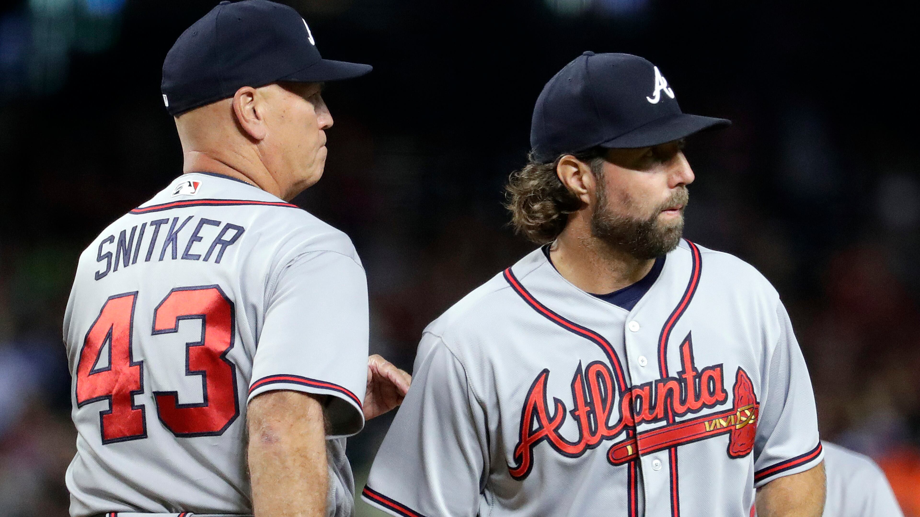 Braves starting pitcher R.A. Dickey (right) is pulled by manager Brian Snitker during the fourth inning against the Arizona Diamondbacks, Monday, July 24, 2017, in Phoenix.