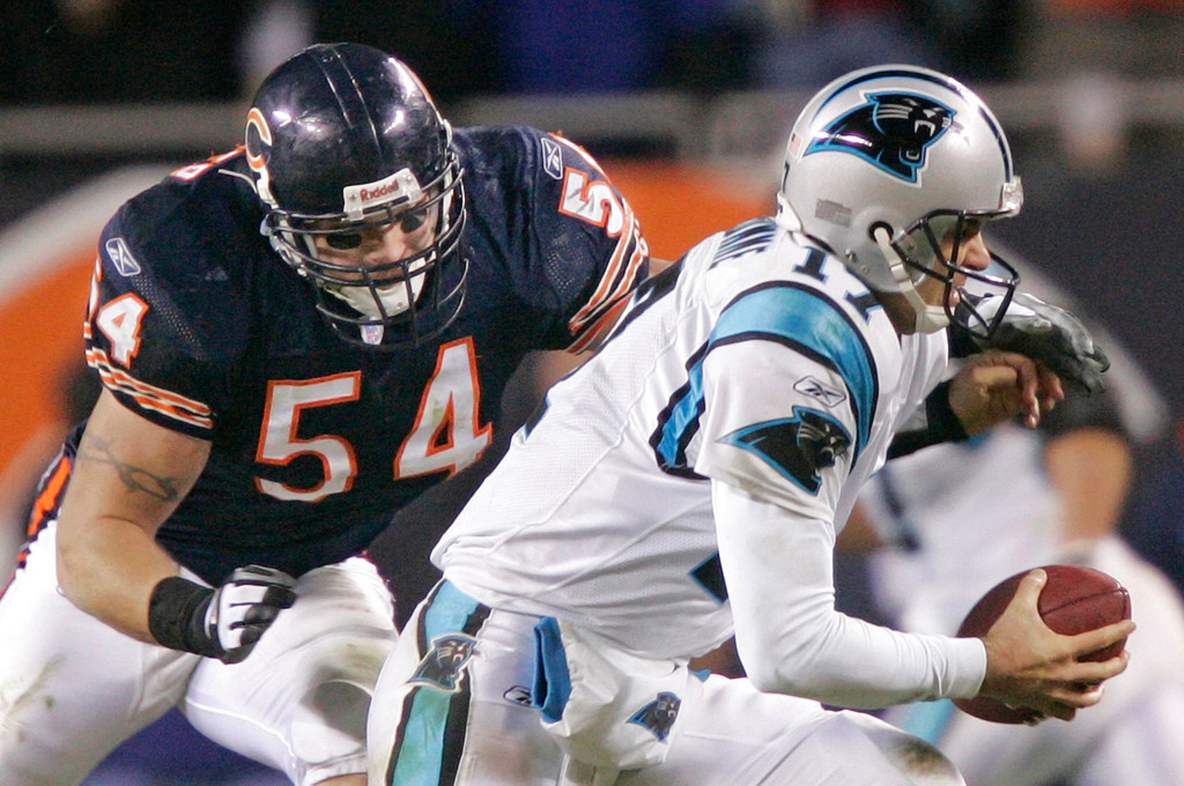 FILE - In this Jan. 15, 2006, file photo, Chicago Bears' linebacker Brian Urlacher (54) attempts to sack Carolina Panthers' quarterback Jake Delhomme (17) in the third quarter of their NFC divisional playoff football game in Chicago. Urlacher was elected to the Pro Football Hall of Fame on Saturday, Feb. 3, 2018. (AP Photo/Morry Gash, File)