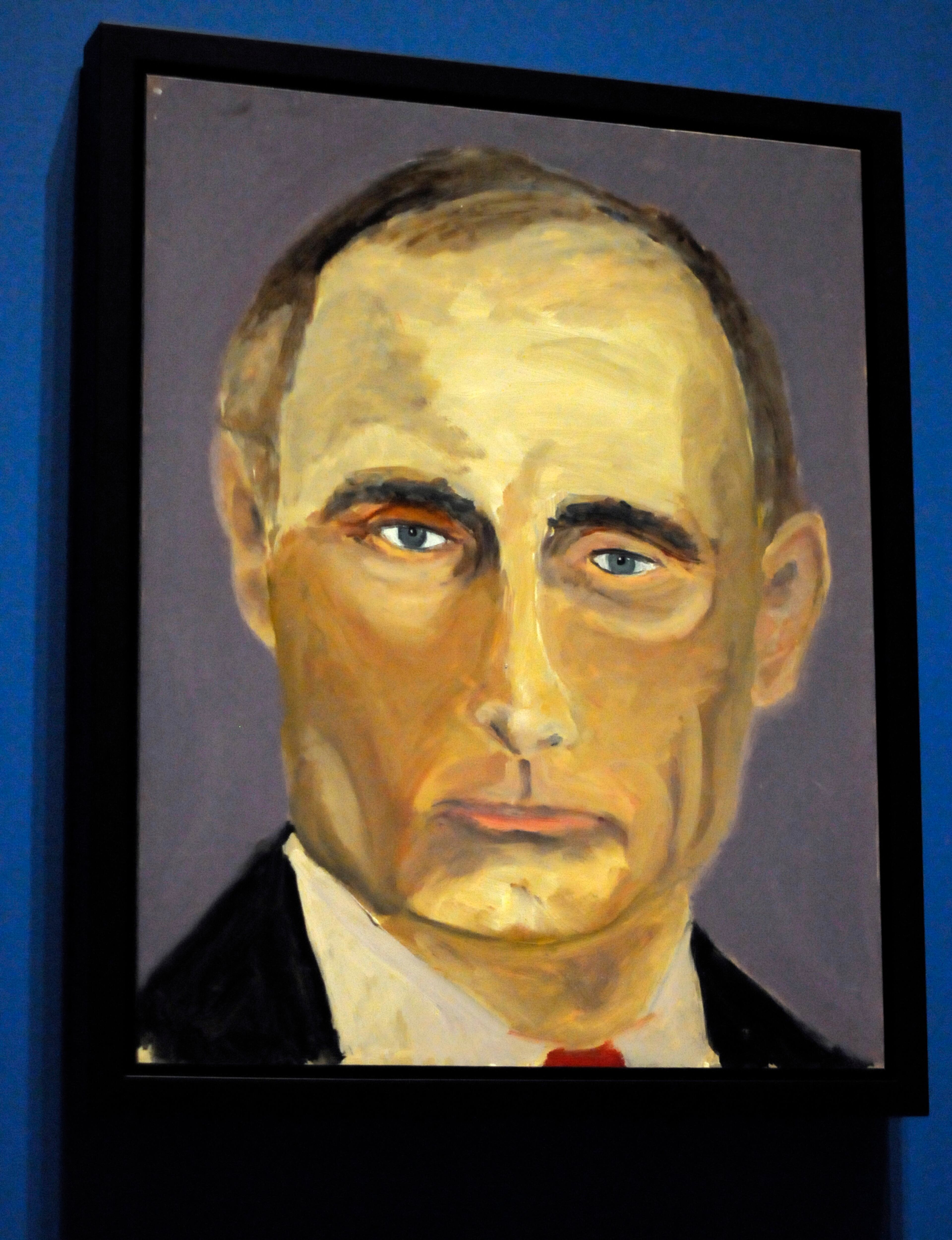 A portrait of Russian President Vladimir Putin which is part of the exhibit "The Art of Leadership: A President's Diplomacy," is on display at the George W. Bush Presidential Library and Museum in Dallas, Friday, April 4, 2014. The exhibit of portraits of world leaders painted by former President George W. Bush opens Saturday and runs through June 3. (AP Photo/Benny Snyder)