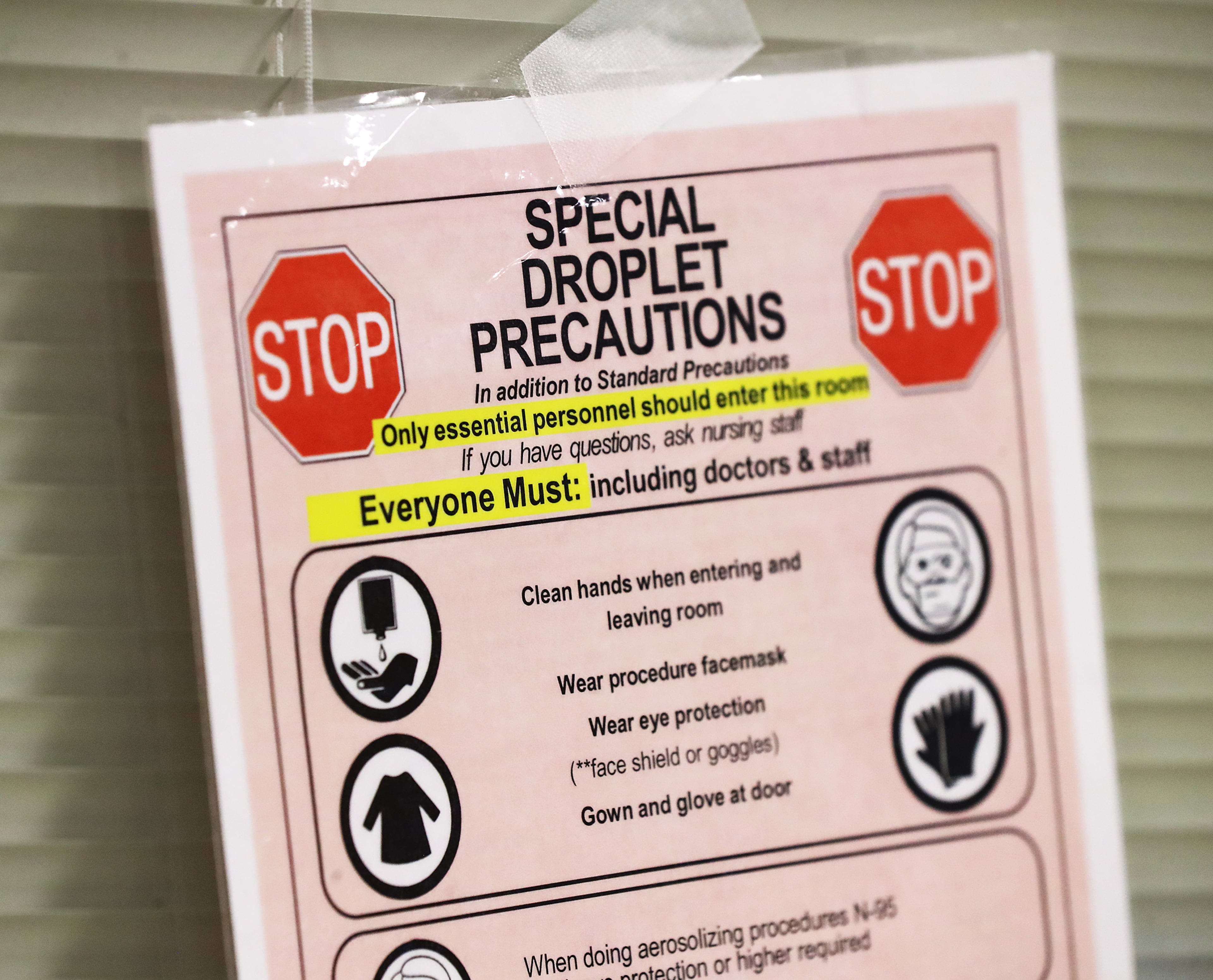 Emergency rooms with COVID patients are marked with special droplet precautions signs inside the emergency department at Colquitt Regional Medical Center. As hospital wards overflow, the ER can become a holding zone for patients requiring a bed, even though they’re not specially designed to keep staff safe from COVID-19. (Curtis Compton / Curtis.Compton@ajc.com)