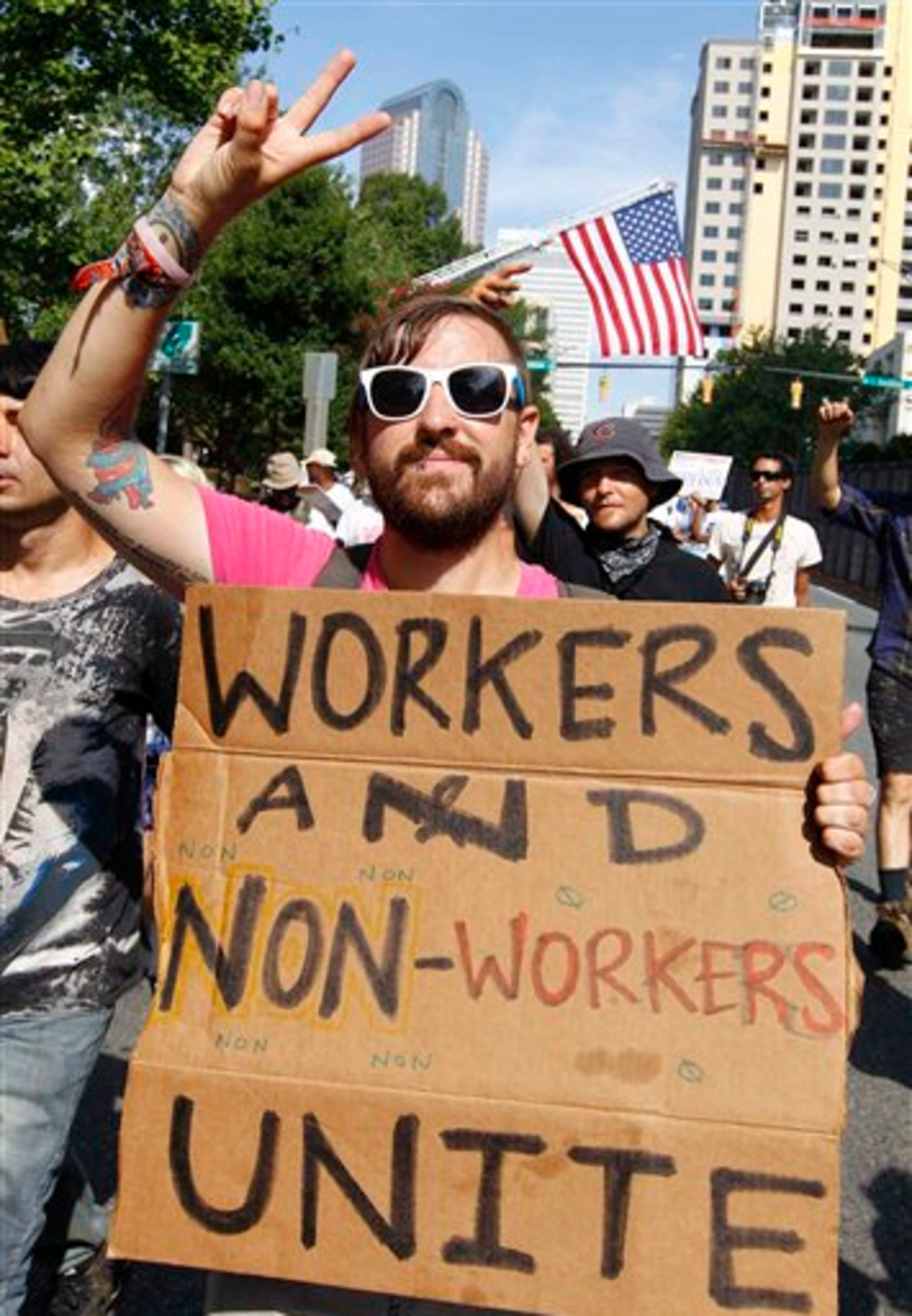 Demonstrators march in a Labor Day parade, Monday, Sept. 3, 2012, in Charlotte, N.C. Demonstrators are protesting before the start of the Democratic National Convention. (AP Photo/Chuck Burton)