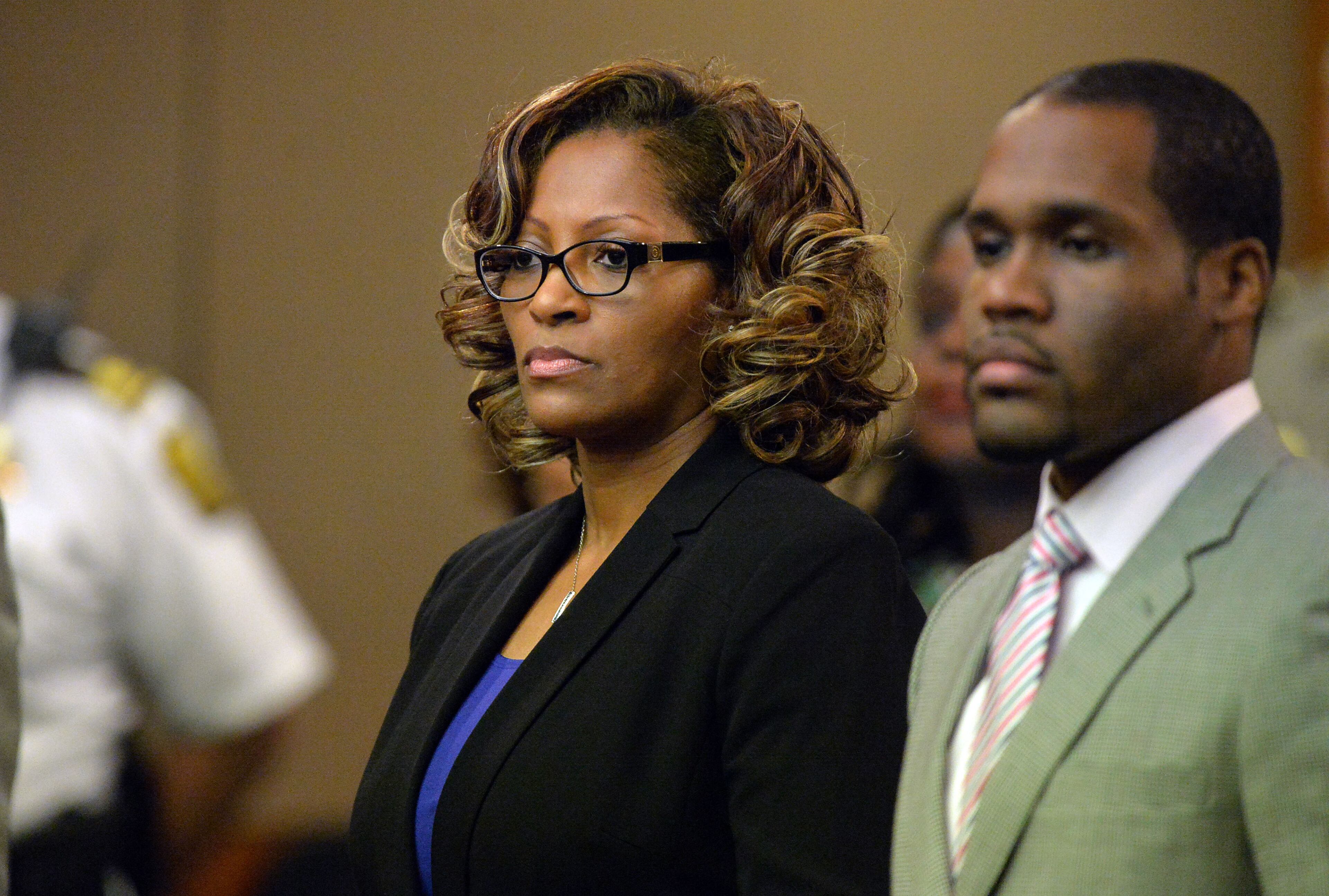 Former APS Dobbs Elementary teacher Angela Williamson and her defense attorney Gerald Griggs stand as the verdict is read. She was convicted of Violation of Racketeer Influenced and Corrupt Organizations Act charges. A jury of six men and six women render convicted 11 of 12 defendants on RICO and other assorted charges on their eighth day of deliberations in the Atlanta Public Schools test-cheating trial on Wednesday, April 1, 2015. Jurors sorted through roughly five months of testimony against 12 former educators accused of engaging in a racketeering conspiracy to inflate test scores. (Atlanta Journal-Constitution, Kent D. Johnson, Pool)