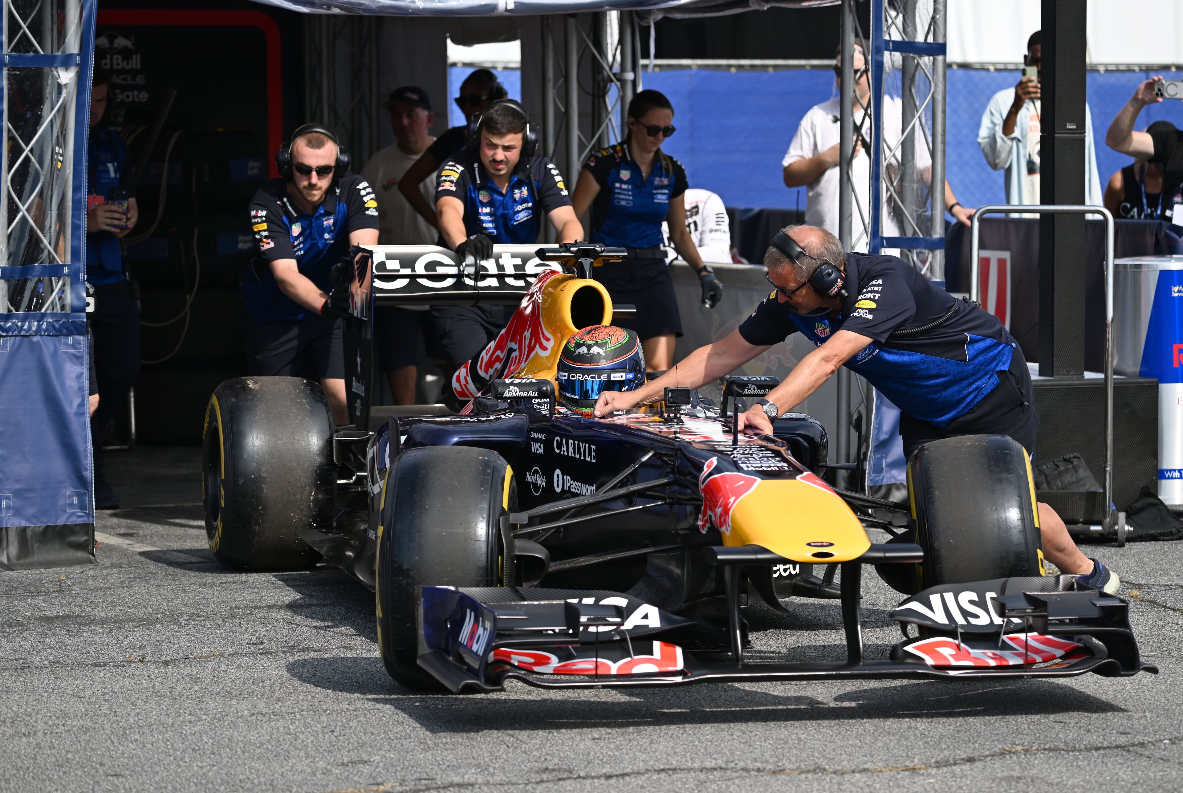 A driver of the Oracle Red Bull Racing Formula One car leaves the paddock before a demonstration run on Hank Aaron Drive during the Red Bull Showrun Atlanta Presented by Ford Racing on Saturday, Aug. 1, 2026, in Atlanta. Atlanta city officials this week approved permits for the Red Bull Showrun that will allow the live motorsports demonstration event to go on as advertised along a roughly half-mile stretch of Hank Aaron Drive — a backup location after earlier plans to hold the event near Piedmont Park ran into opposition from Midtown residents. (Hyosub Shin/AJC)