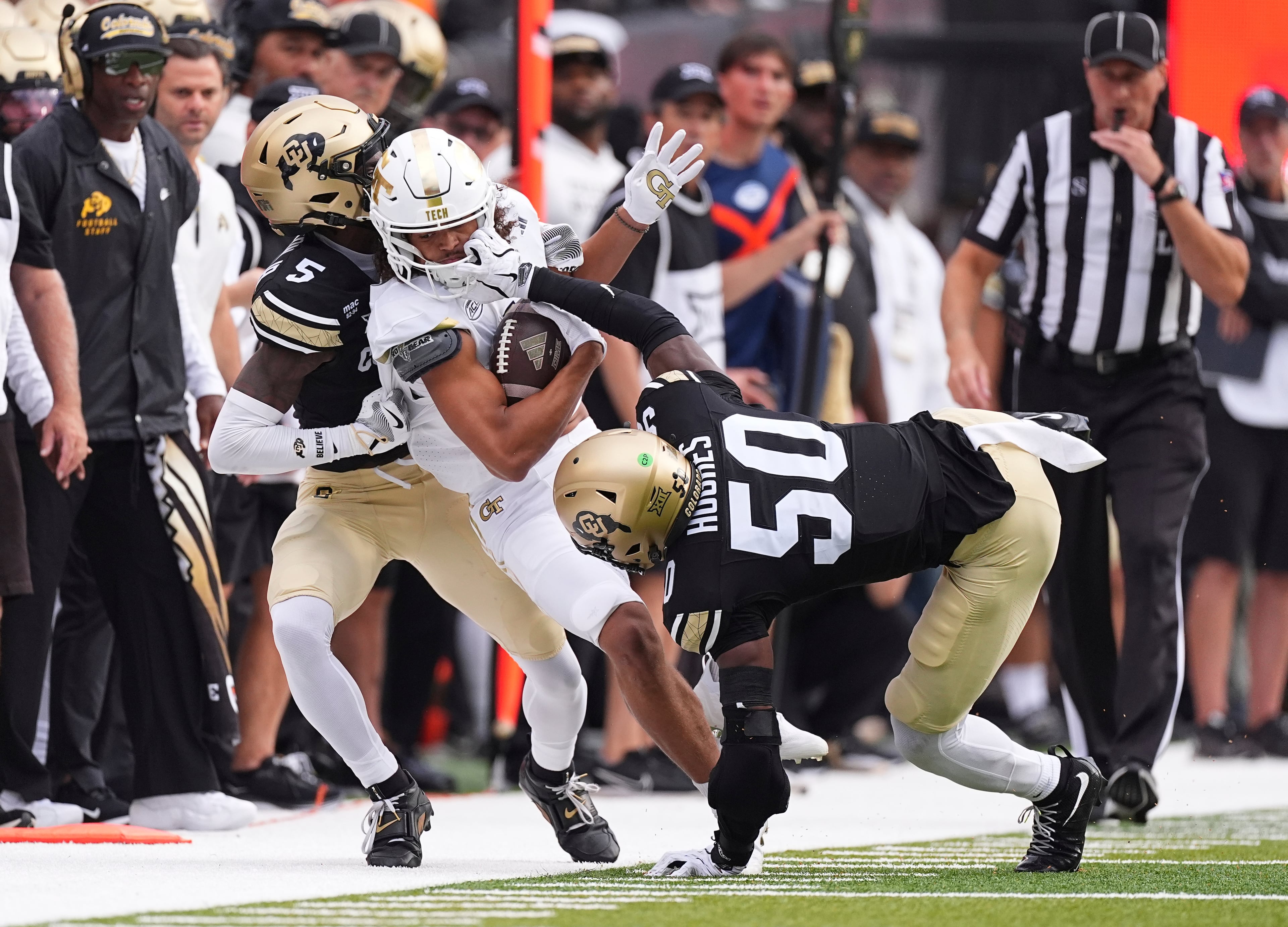 Georgia Tech wide receiver Isiah Canion (center) is tackled after pulling in a pass by Colorado cornerback Preston Hodge (left) and linebacker Reginald Hughes during the first half on Friday, Aug. 29, 2025, in Boulder, Colo. (David Zalubowski/AP)
