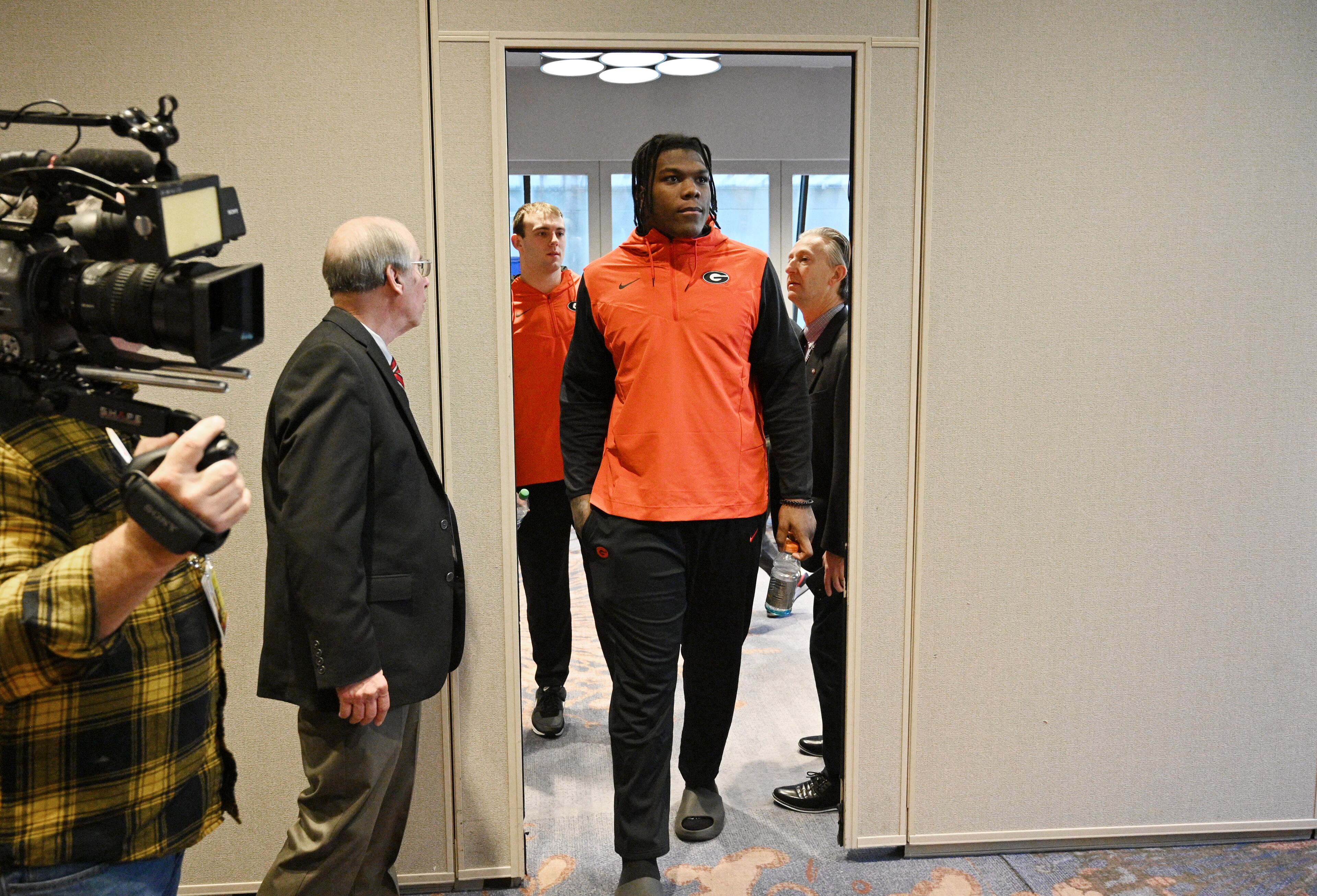 Offensive lineman Broderick Jones enters for Georgia's press conference ahead of the Chick-fil-A Peach Bowl at The Westin Peachtree Plaza in Atlanta on Wednesday, Dec. 28, 2022. (Hyosub Shin / Hyosub.Shin@ajc.com)