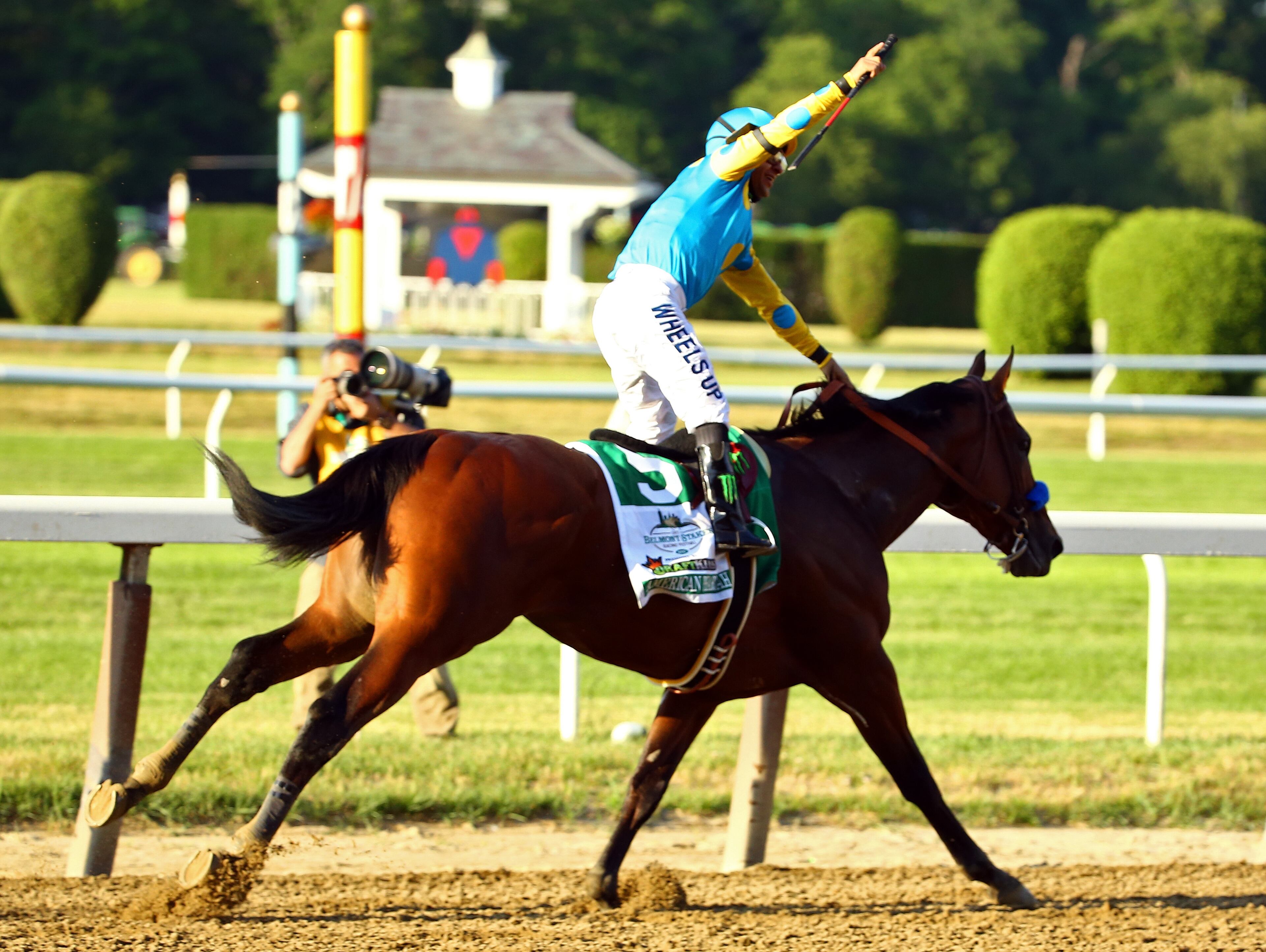 ELMONT, NY - JUNE 06: Victor Espinoza, celebrates atop American Pharoah #5, after winning the 147th running of the Belmont Stakes at Belmont Park on June 6, 2015 in Elmont, New York. With the wins American Pharoah becomes the first horse to win the Triple Crown in 37 years. (Photo by Al Bello/Getty Images)