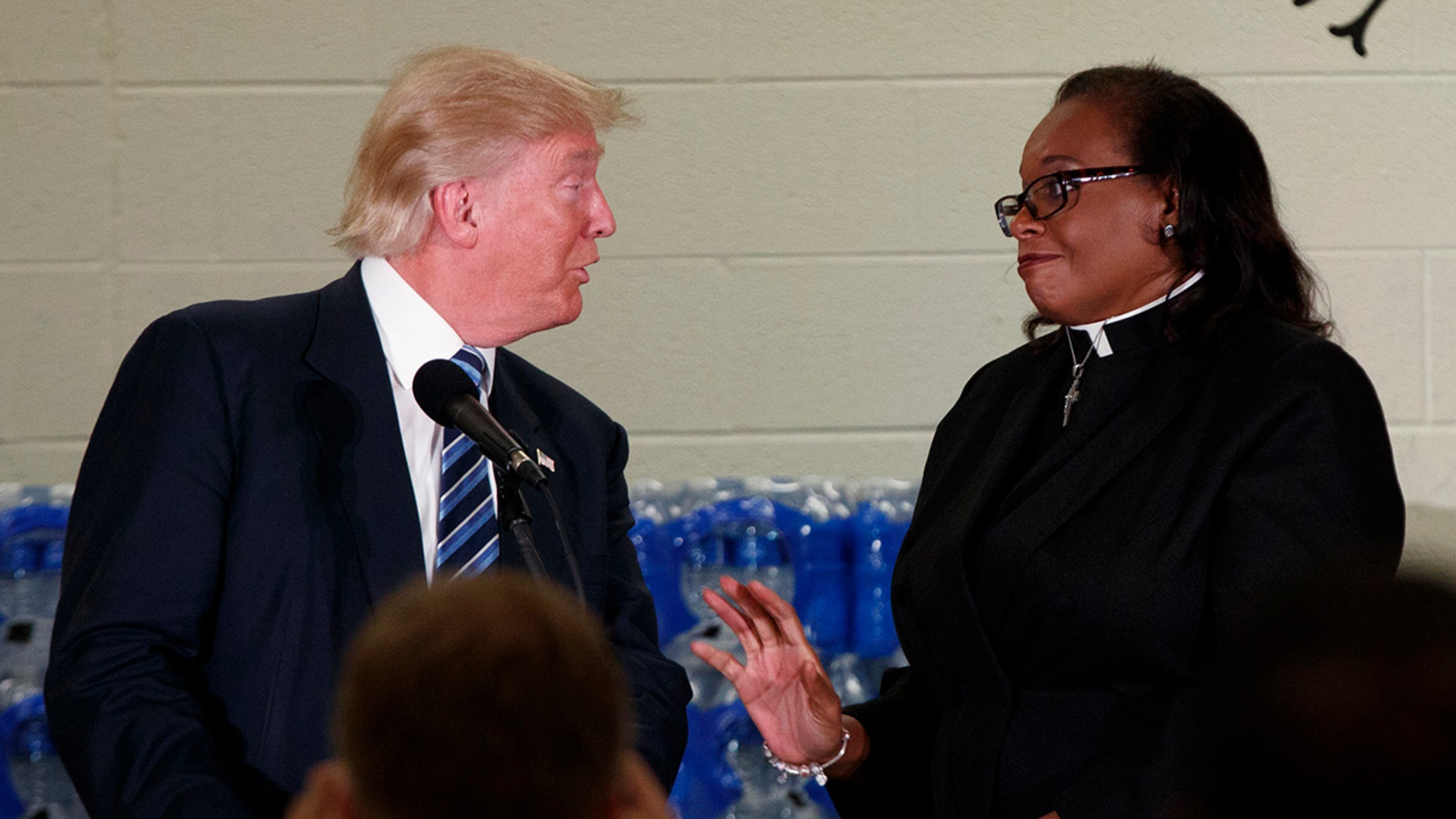 Rev. Faith Green Timmons interrupts Republican presidential candidate Donald Trump as he spoke during a visit to Bethel United Methodist Church, Wednesday, Sept. 14, 2016, in Flint, Mich. Timmons asked that Trump not deliver a political speech, and keep his message to the people of Flint. (AP Photo/Evan Vucci)