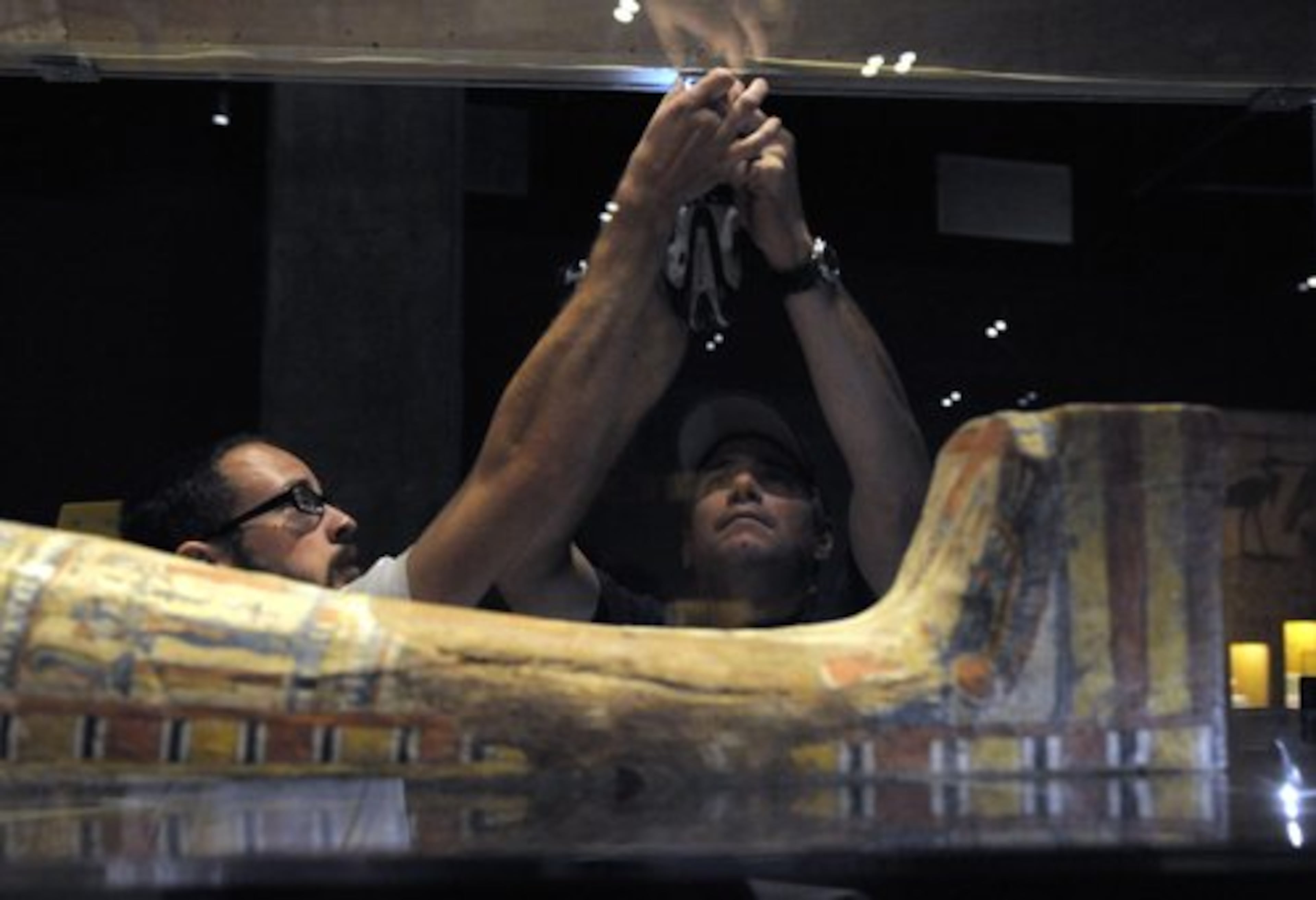 Eric Rossi and John Diloszycki close the case on an Egyptian sarcophagus and mummy in Los Angeles in preparation for the opening of the new Mummies of the World exhibit at the California Science Center.