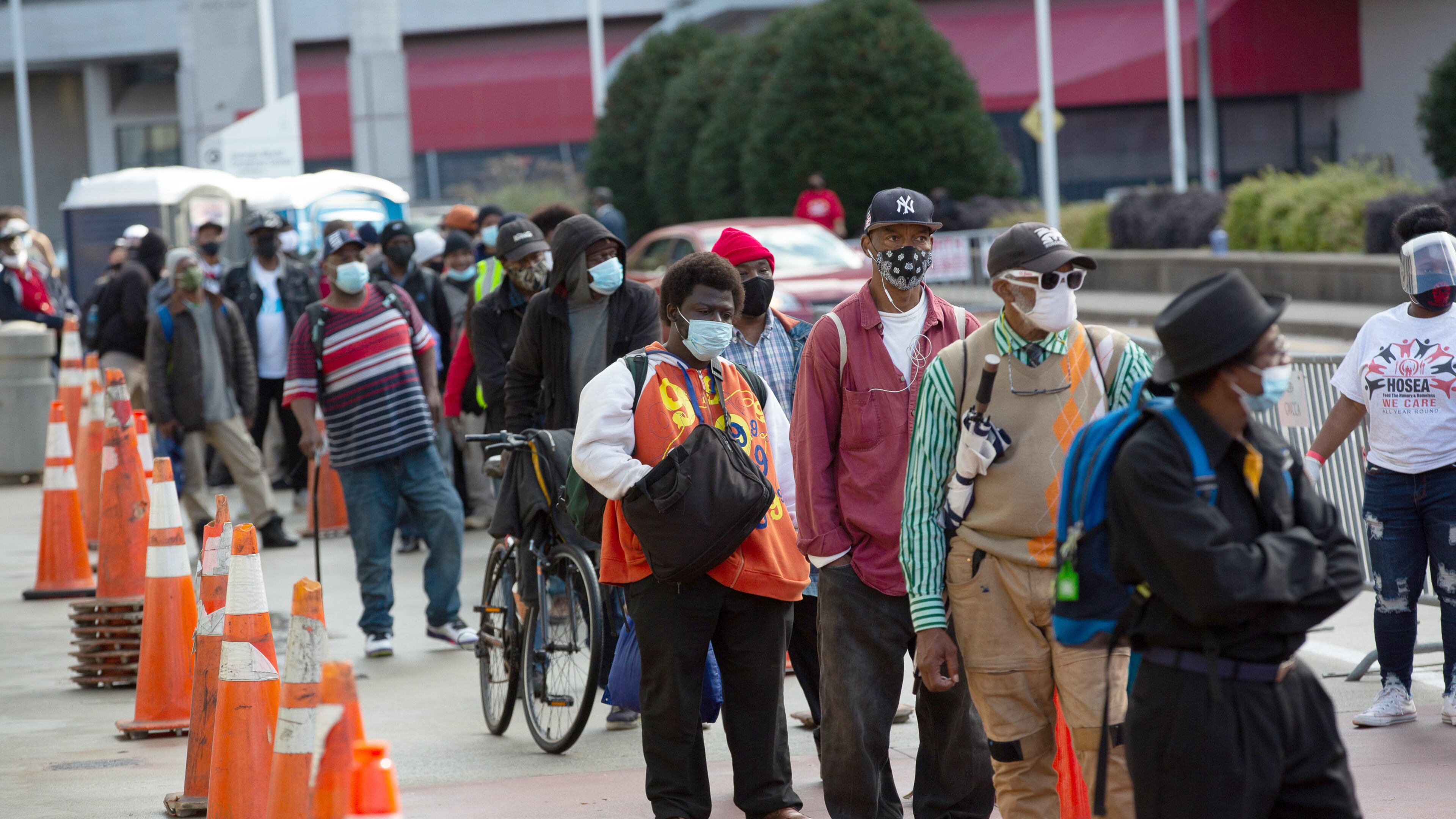 People line up for the annual Hosea Helps Thanksgiving meal distribution outside the Georgia World Congress Center on Thursday, November 26, 2020. The Christmas giveaway event will be drive-thru. (Photo: Steve Schaefer for The Atlanta Journal-Constitution)