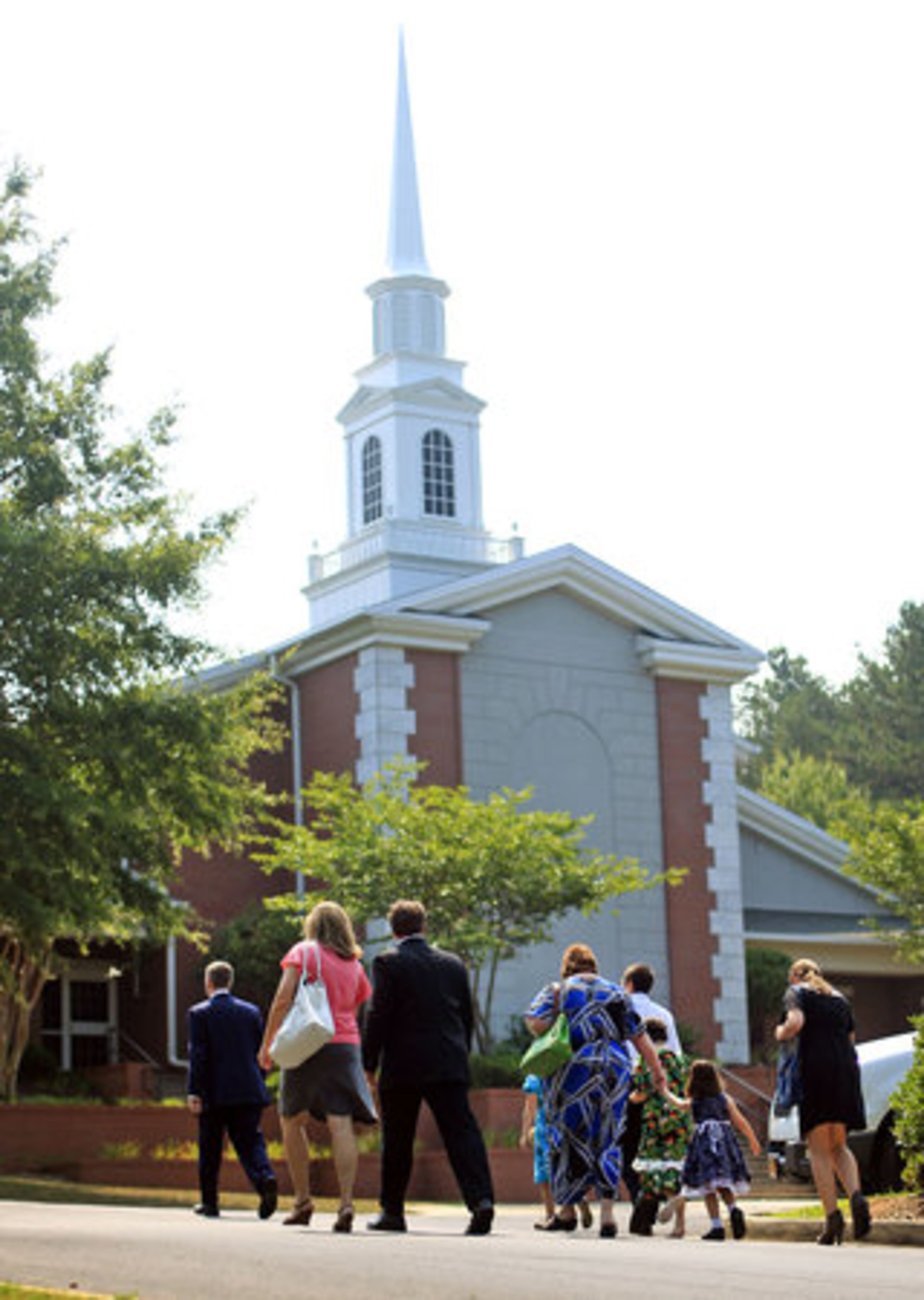 A family walks to the Church of Jesus Christ of Latter-Day Saints for the funeral of brothers Jake and Griffin Prince.