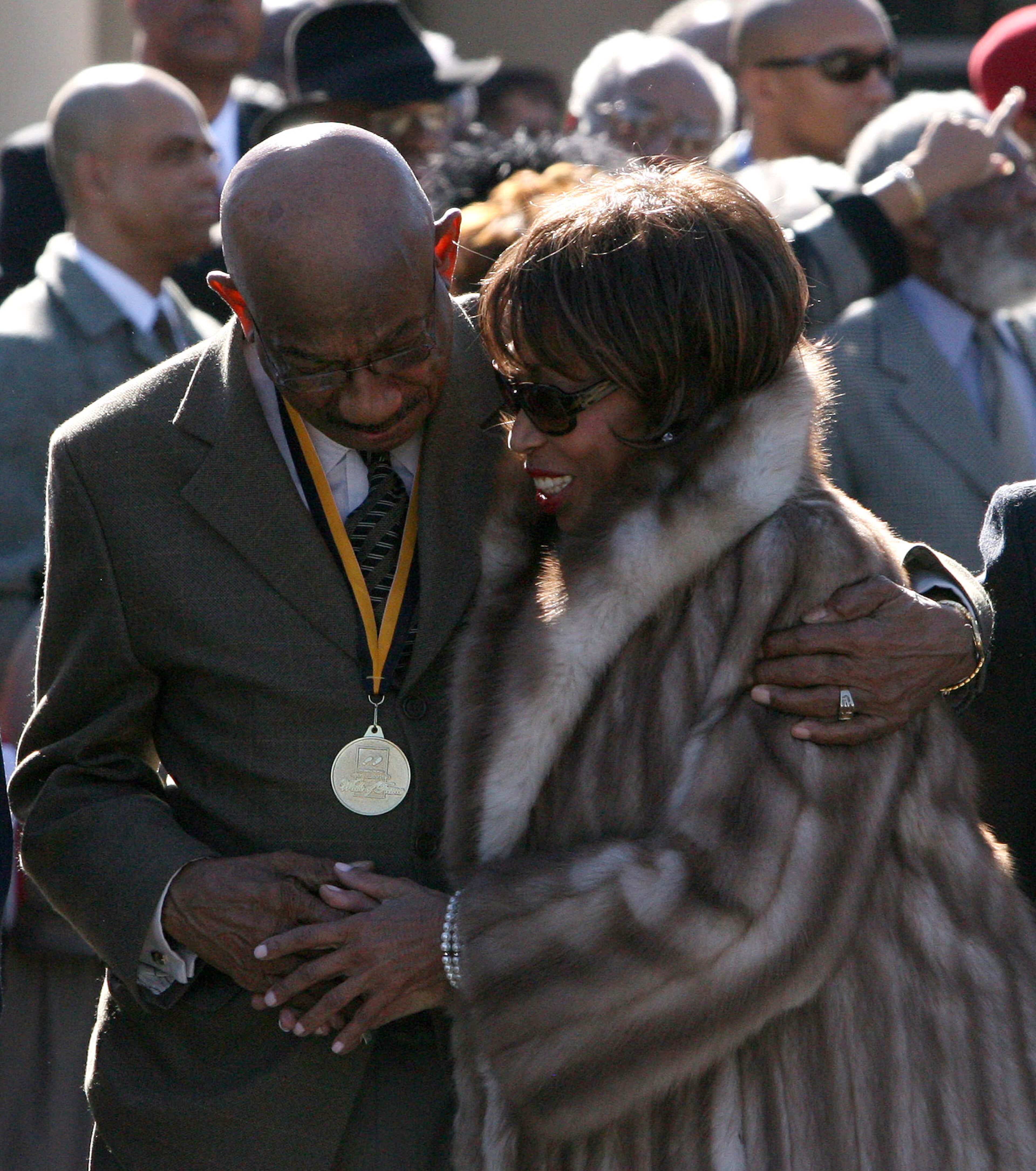 Herman J. Russell hugs Altovise Davis, wife of Sammy Davis Jr. at the International Civil Rights Walk of Fame at the Martin Luther King Center. Russell and Sammy Davis Jr. both have footprints on the walk of fame.