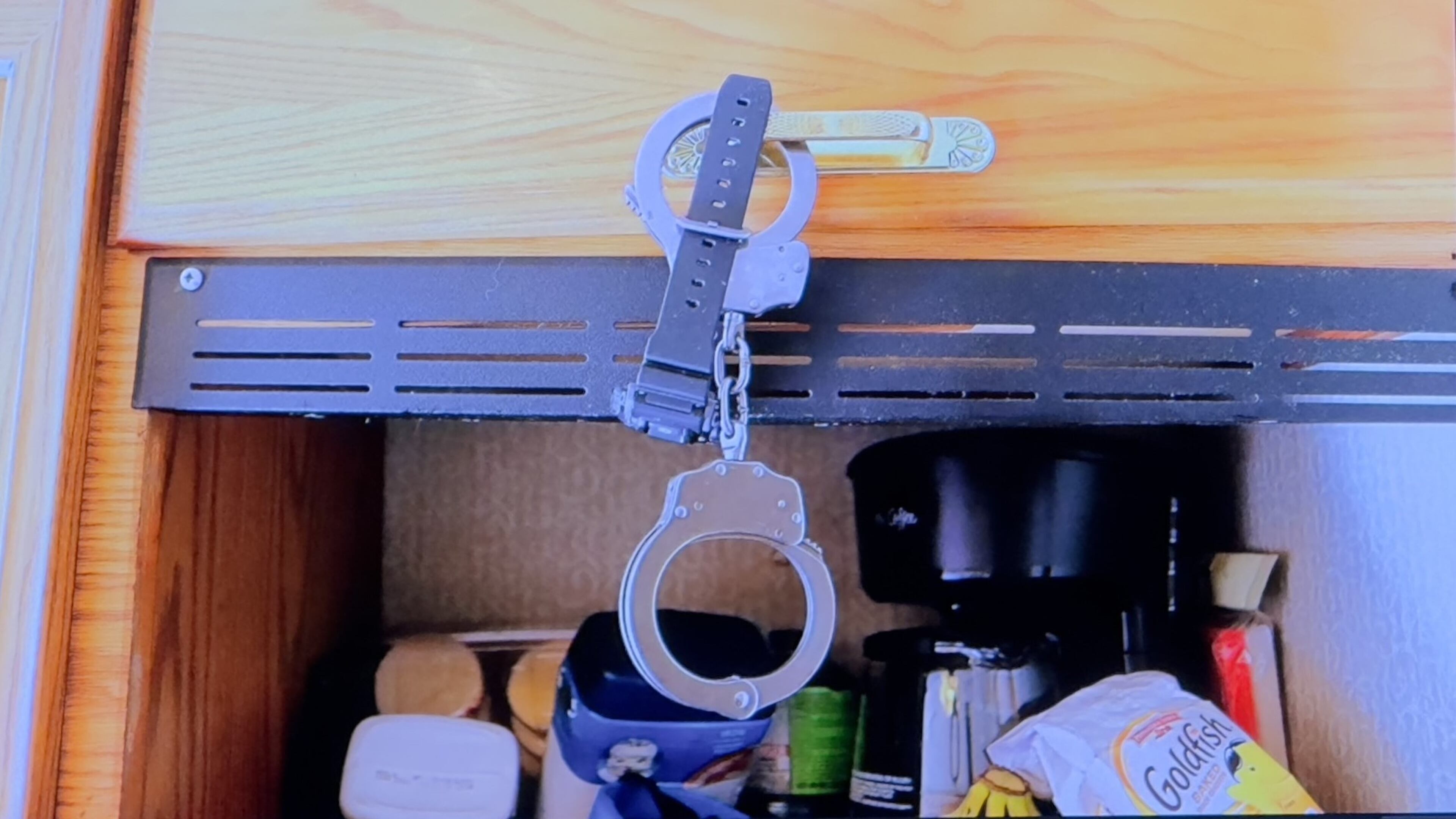 Prosecutors showed jurors this photograph of handcuffs that investigators found inside Christopher Scott Palmer's motor home during their investigation of 9-month-old Cody Palmer's death in early 2022. (Joe Kovac Jr. / AJC)