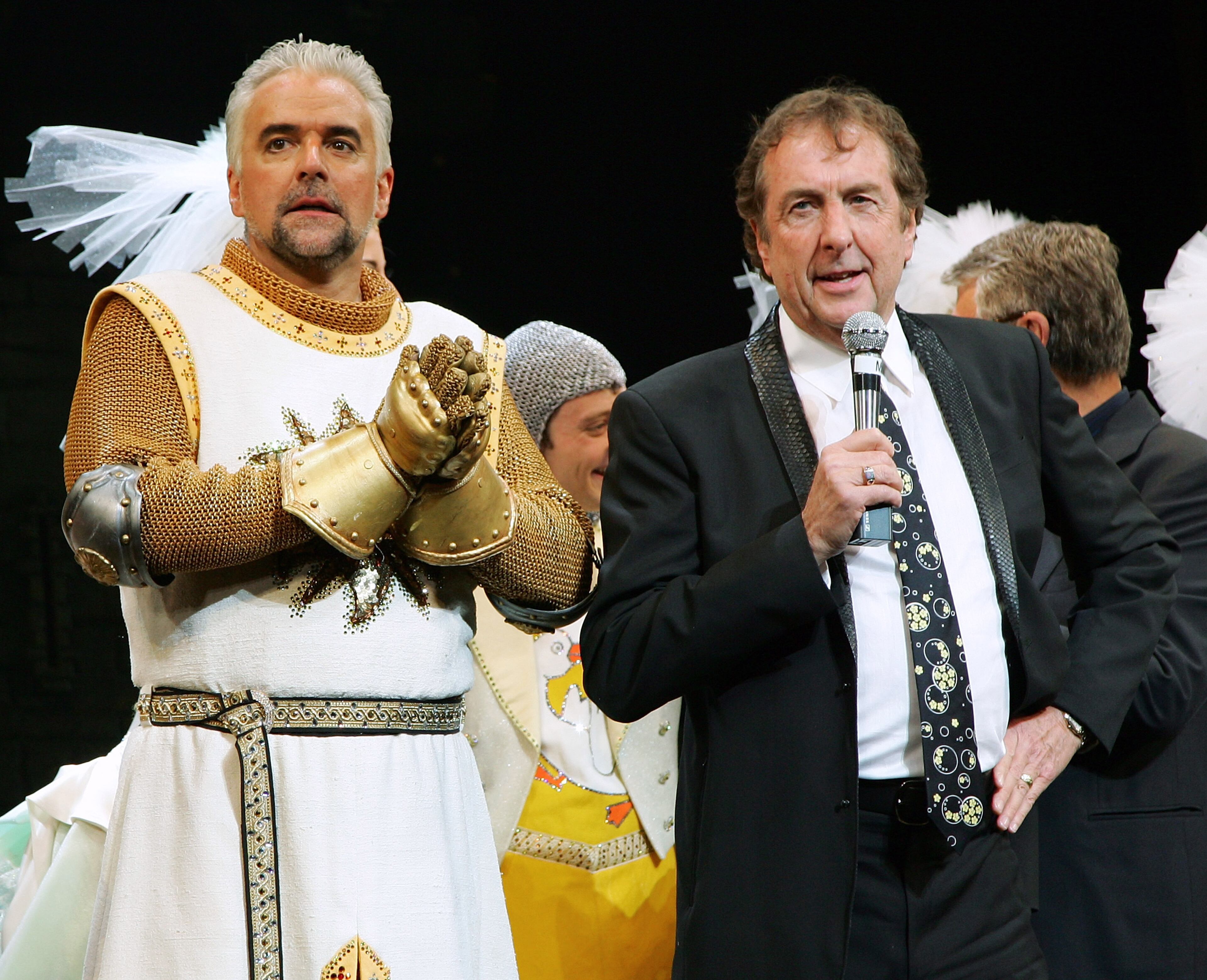 LAS VEGAS - MARCH 31: Actor John O'Hurley (L) looks on as actor/writer Eric Idle talks to the audience during the curtain call of the premiere of "Monty Python's Spamalot" at The Grail Theater at the Wynn Las Vegas March 31, 2007 in Las Vegas, Nevada. (Photo by Ethan Miller/Getty Images)
