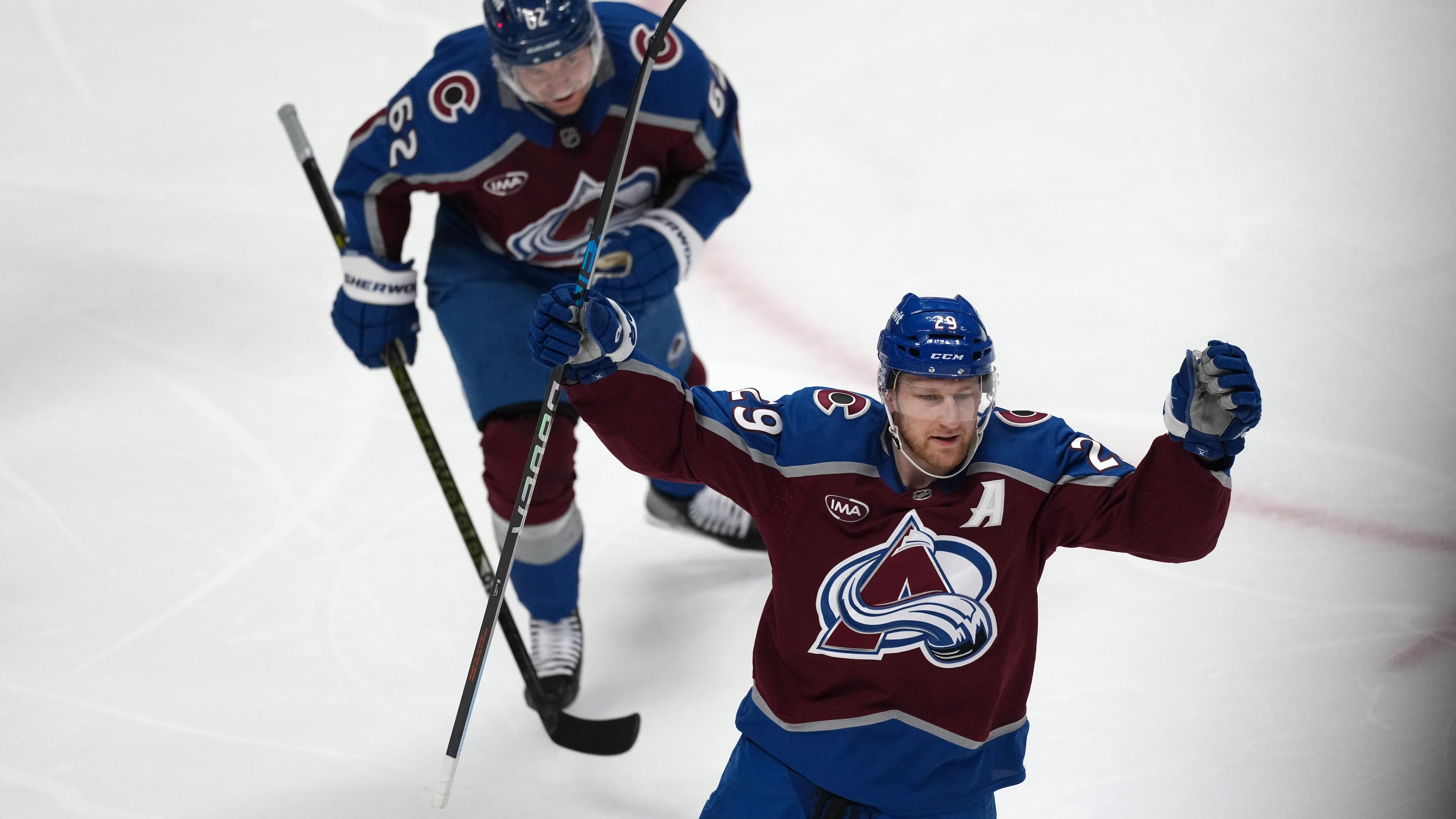 Colorado Avalanche center Nathan MacKinnon, front, and left wing Artturi Lehkonen react after center Martin Necas scored a goal against the Minnesota Wild in the first period of Game 2 of an NHL hockey Stanley Cup second-round playoff series Tuesday, May 5, 2026, in Denver. (AP Photo/David Zalubowski)