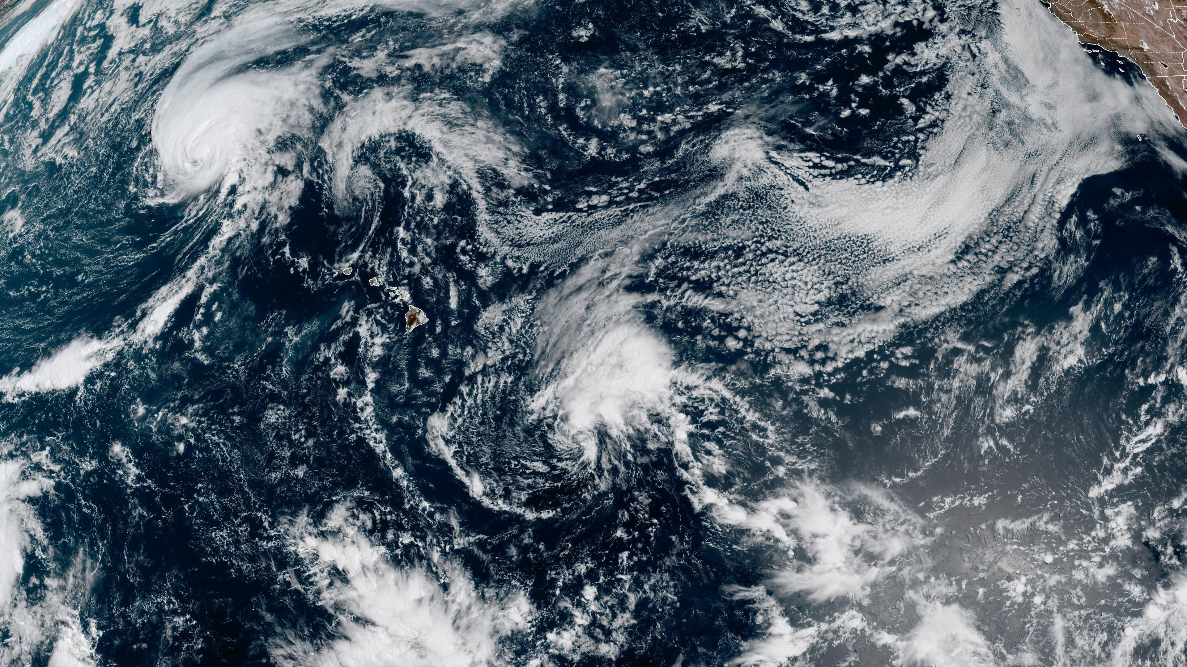 This satellite image released by NOAA shows Hurricane Lala, upper left, over the Pacific Ocean, northwest of Hawaii, Friday, Aug. 21, 2026. (NOAA via AP)