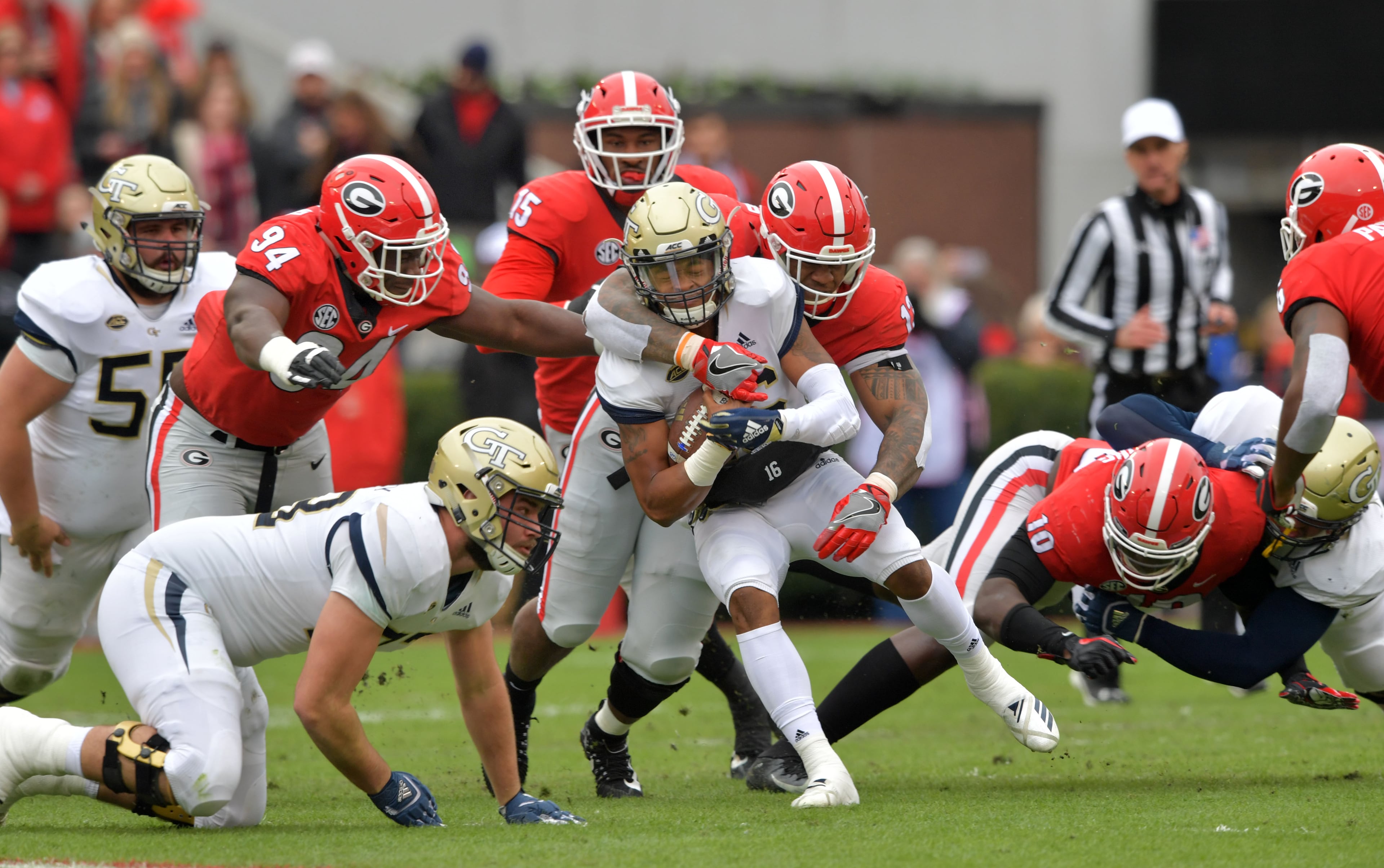 November 24, 2018 Athens - Georgia Tech quarterback TaQuon Marshall (16) gets tackled from behind by Georgia defensive end Jonathan Ledbetter (13) during the second half in a NCAA college football game at Sanford Stadium on Saturday, November 24, 2018. Georgia won 45 - 21 over the Georgia Tech. HYOSUB SHIN / HSHIN@AJC.COM