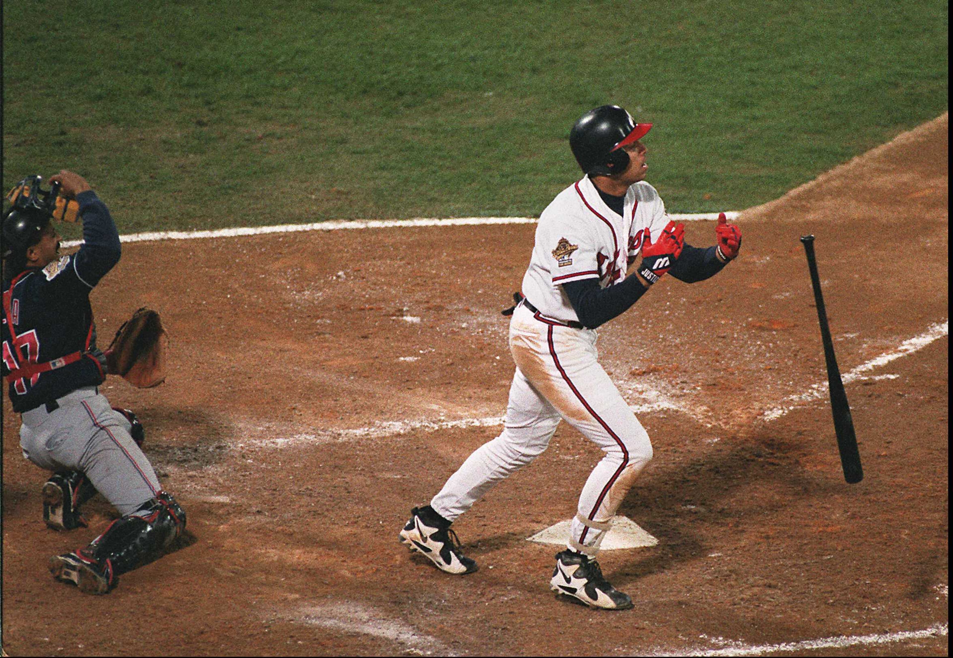 David Justice watches his 6th inning home run go out of the park as Cleveland catcher Tony Pena watches.