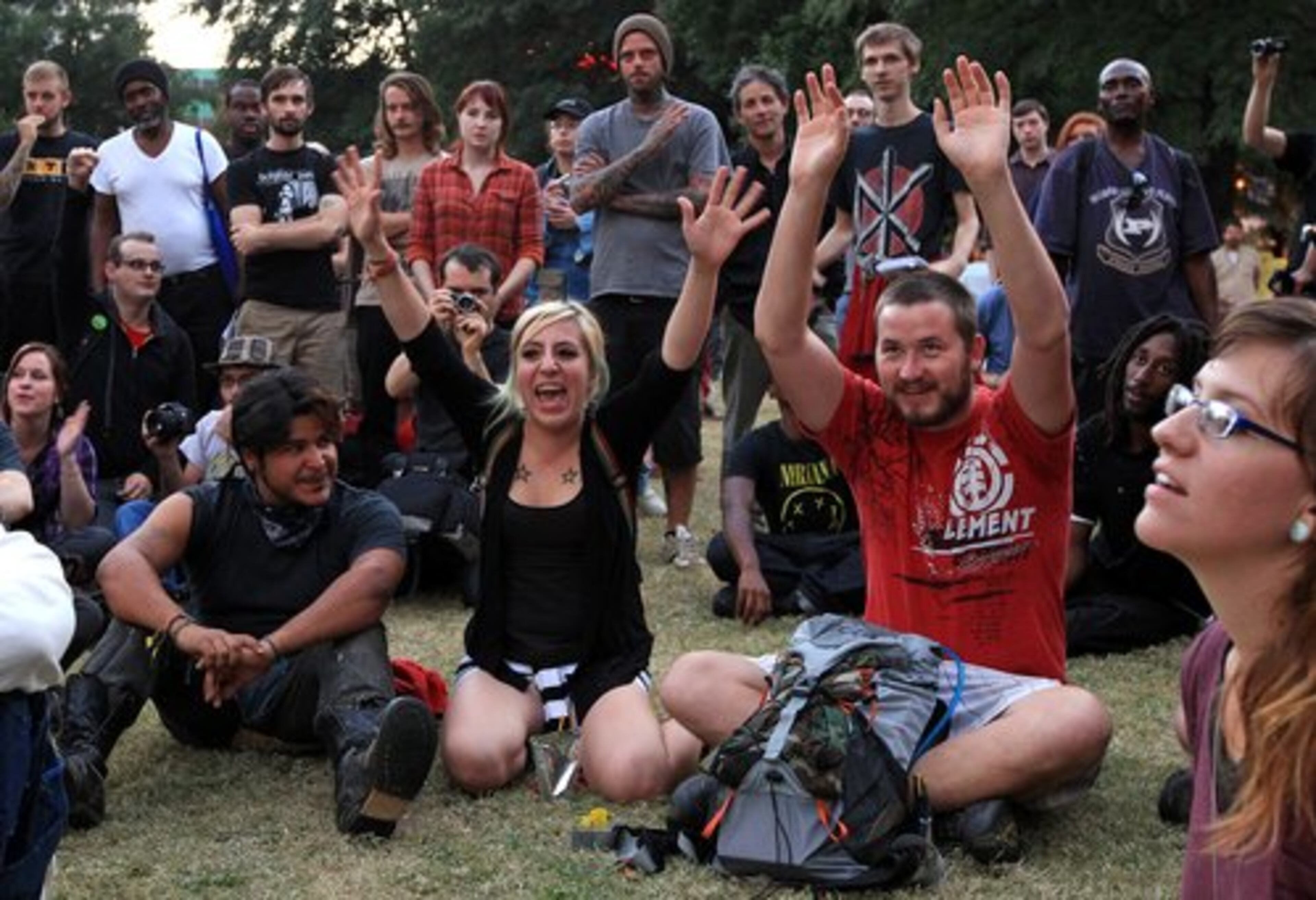 Occupy Atlanta members react with celebration during a general assembly in Woodruff Park as leaders announce the city extended the deadline to leave the park on Monday, Oct. 17, 2011. Atlanta Mayor Kasim Reed extended the executive order allowing the group to remain through the adjournment of the next Atlanta City Council meeting on Nov. 7, 2011.