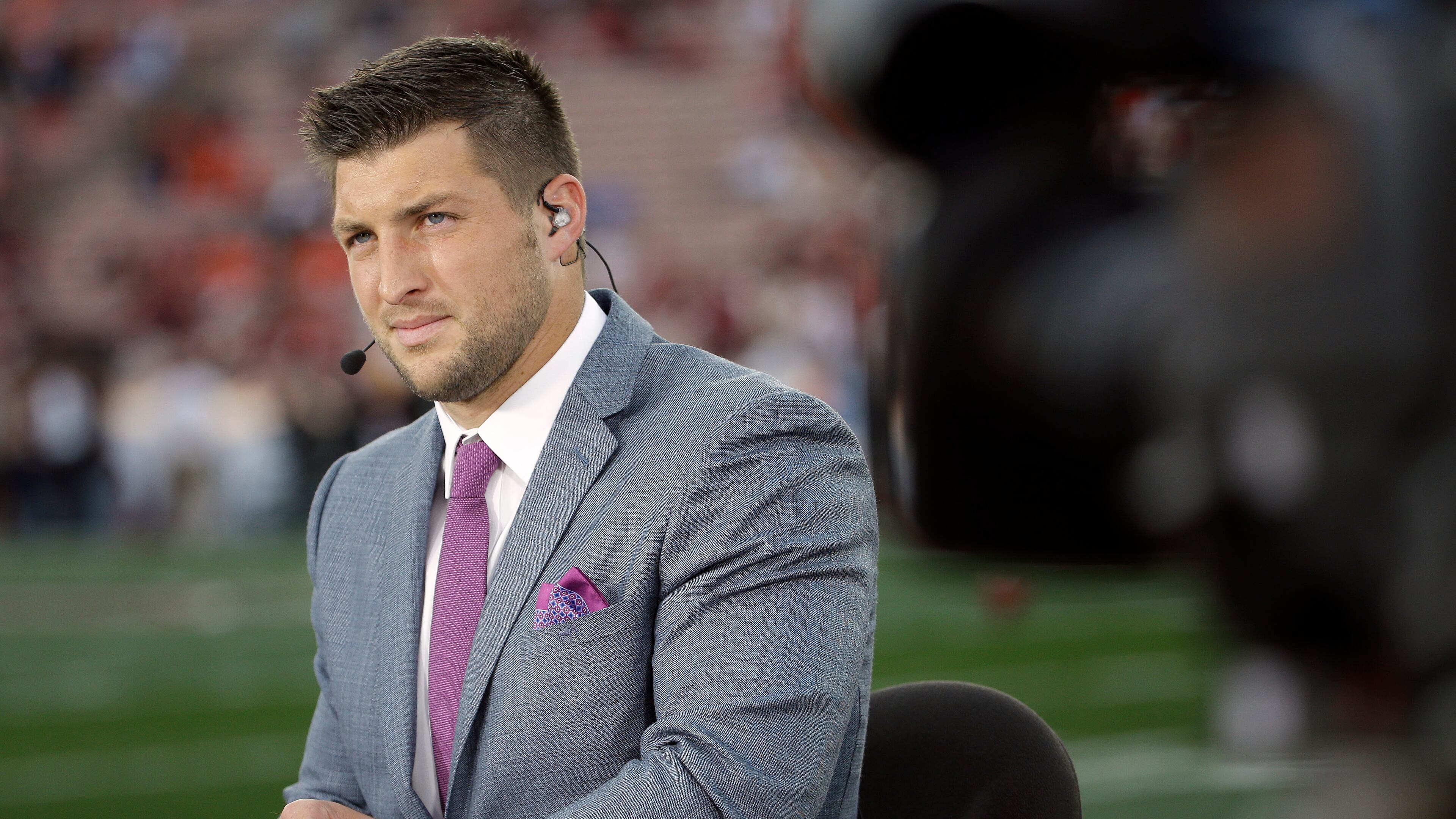 FILE - Tim Tebow speaks on ESPN before the NCAA BCS National Championship college football game between Auburn and Florida State in this Monday, Jan. 6, 2014 file photo taken in Pasadena, Calif. Many critics might have written him off and he's got a TV gig with the SEC Network, but as long as the polarizing quarterback is still available, plenty will wonder if anyone will sign him. (AP Photo/David J. Phillip, File) Urban Meyer should know there's a reason Tim Tebow is wearing a suit, not a uniform. (AP)