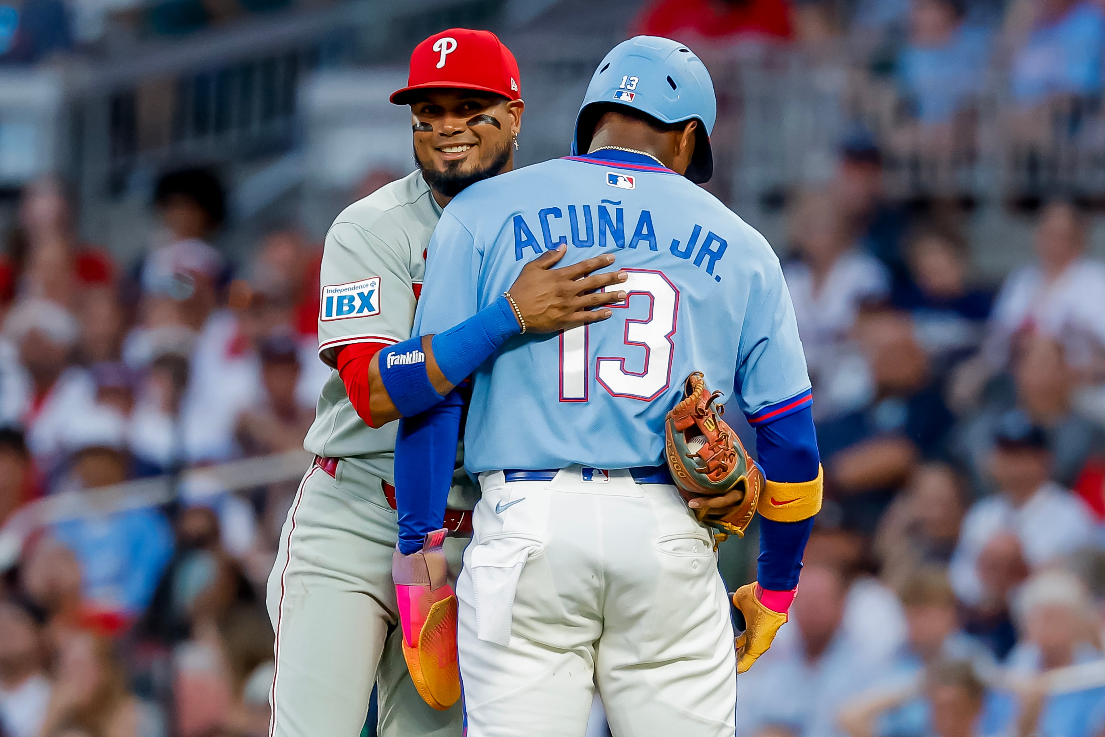 Phillies infielder Luis Arráez tags (and hugs) Ronald Acuña Jr. during a recent game. (Erik S. Lesser/AP)