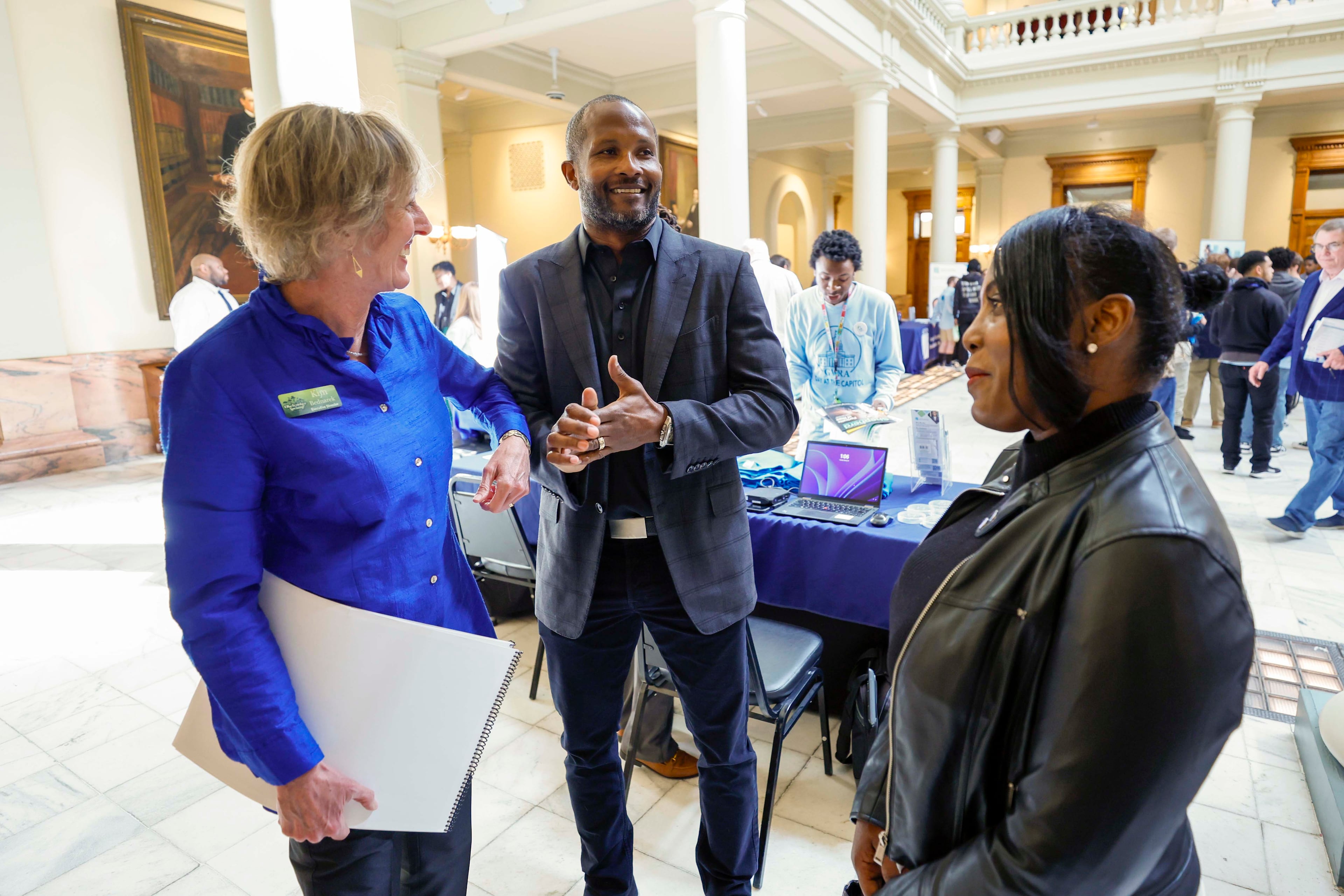 Kim Bednarek, Executive Director of the Okefenokee Swamp Park, left, speaks with Champ Bailey, a board of trustees member, and his sister, Danielle Bailey, during Okefenokee Day at the Georgia state Capitol on Tuesday, Feb 10, 2025. Some of the leaders behind the refuge’s bid to join the World Heritage list held an event to provide updates on the swamp’s bid for WH status.
(Miguel Martinez/AJC)