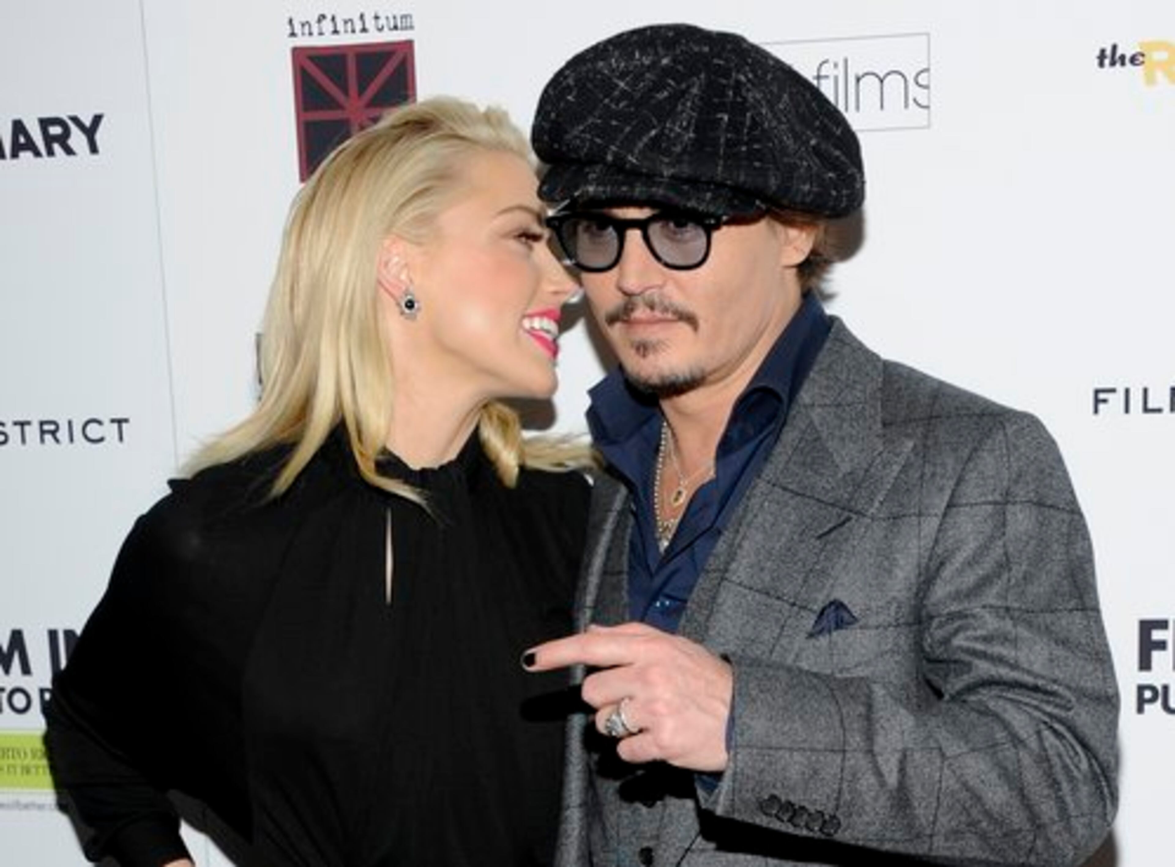 Co-stars Amber Heard and Johnny Depp try to hold a conversation amid the flashing cameras.