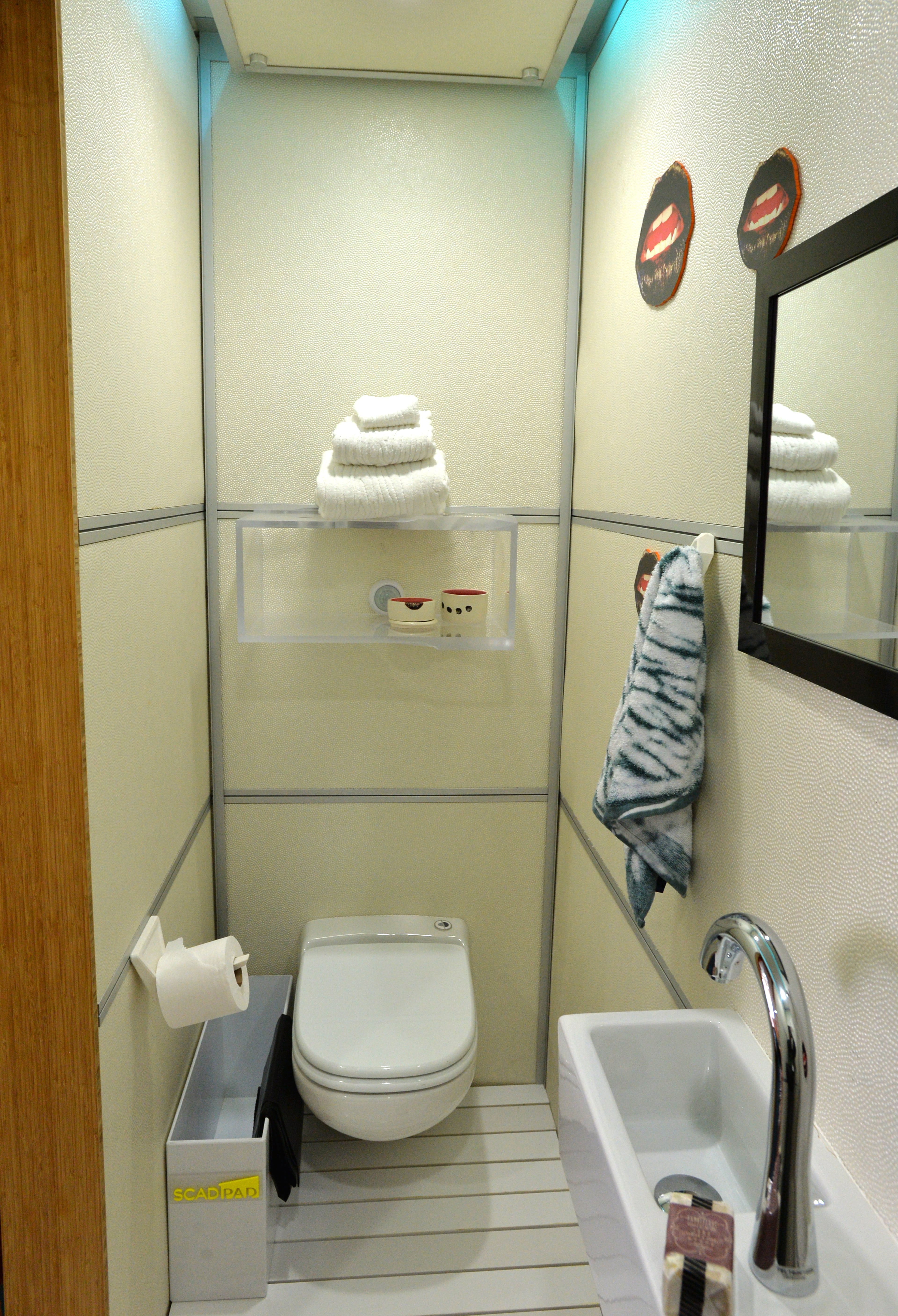 Interior of SCADpad Asia, one of three fully functional and fully furnished 135-square-foot SCADpad units, on the 4th floor of SCAD Atlanta's parking garage on Tuesday, April 15, 2014. Inside SCADpad Asia, a geometic wallpaper adorns the walls, which was painted by BFA and MFA painting graduate Liz Winnel. The wallpaper overlays a soundboard designed by SCAD student Ross Fish. When you touch the wall, an algorithm is triggered to produce randomized audio file sounds. Savannah College of Art and Design (SCAD) unveiled SCADpad, a unique micro-housing and adaptive reuse experiment that transformed the parking structure of its midtown Atlanta location into a sustainable community that proposes an answer to the world's growing urban housing challenges. HYOSUB SHIN / HSHIN@AJC.COM