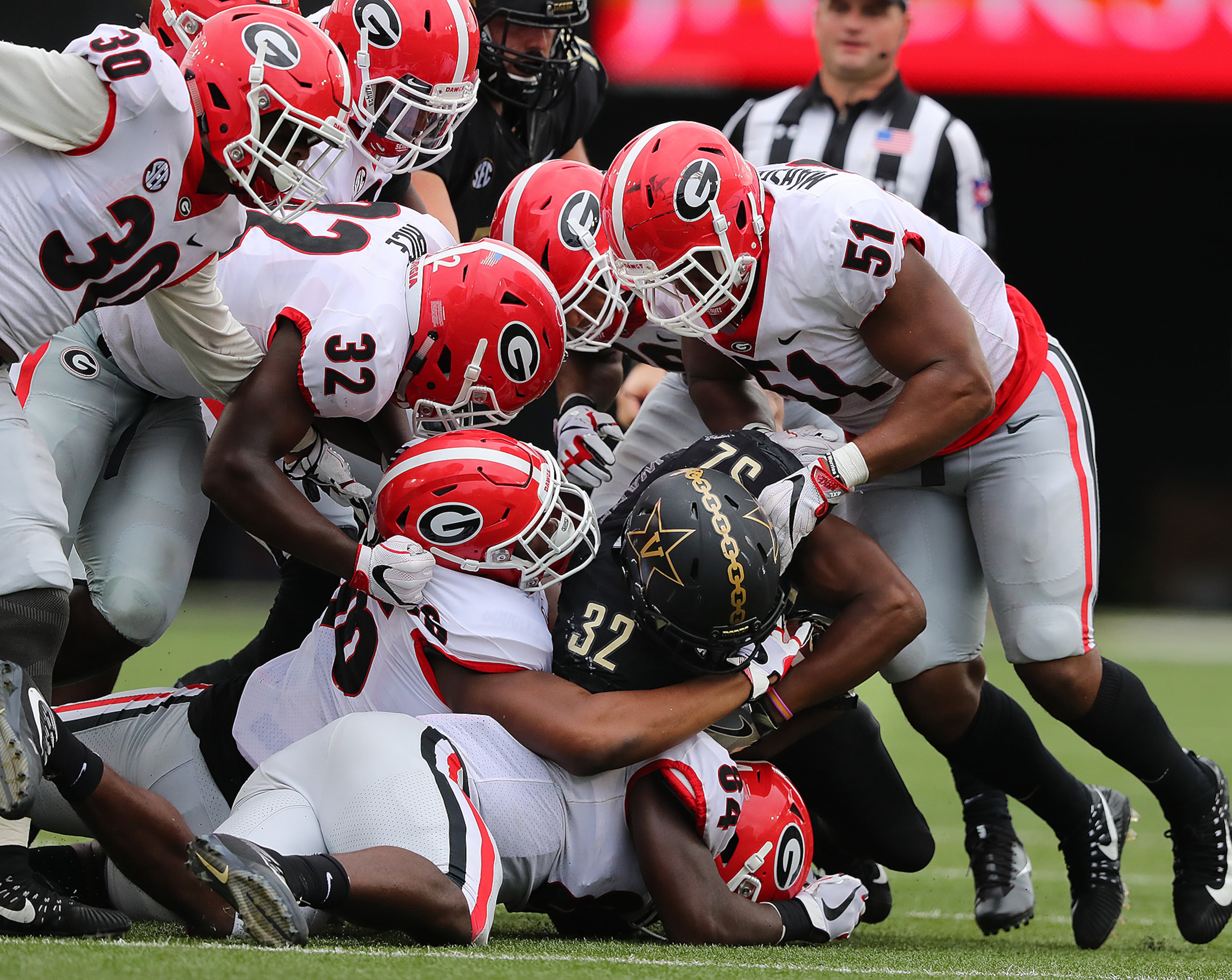 October 7, 2017 Nashville: Georgia defenders smother Vanderbilt running back Jamauri Wakefield for a loss of yardage during the second half in a NCAA college football game on Saturday, October 7, 2017, in Nashville. Curtis Compton/ccompton@ajc.com