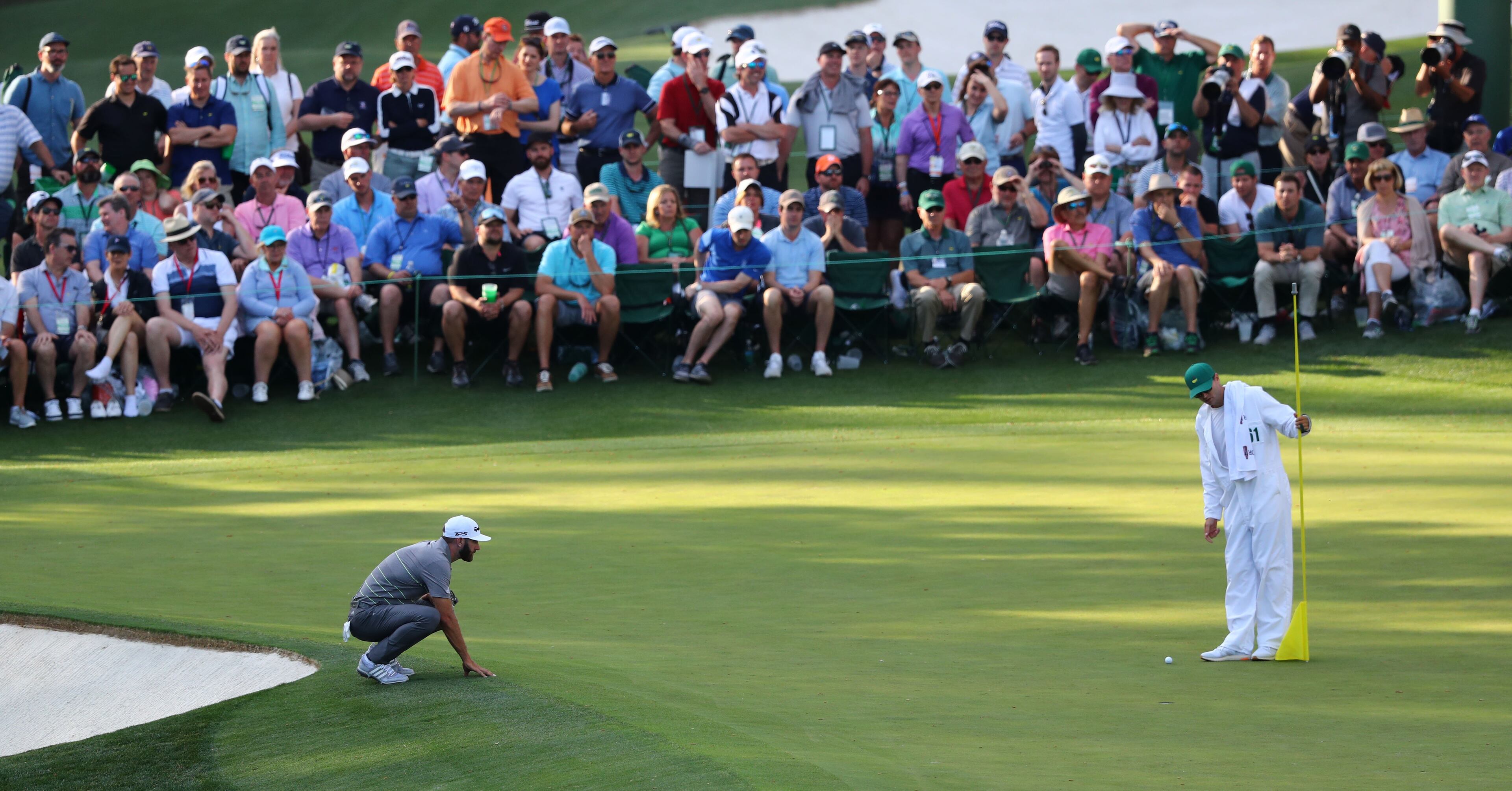 April 11, 2019 - Augusta - Dustin Johnson lines up his putt on 16 during the first round of the Masters Tournament Thursday, April 11, 2019, at Augusta National Golf Club in Augusta. Curtis Compton / ccompton@ajc.com