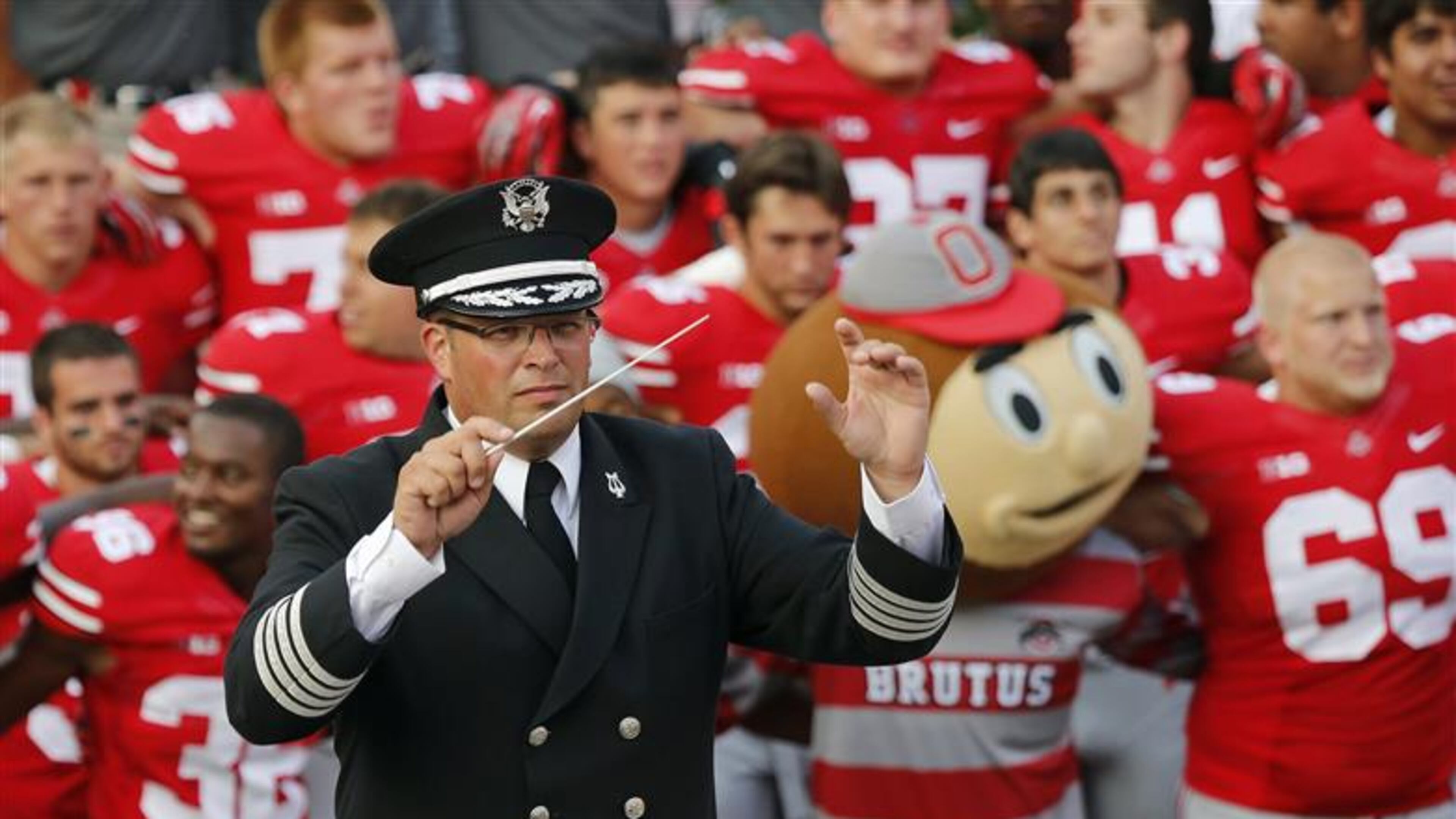 In this Sept. 7, 2013 photo, Ohio State University marching band director Jon Waters leads the band in "Carmen Ohio" following a NCAA football game against San Diego State at Ohio Stadium in Columbus, Ohio. OSU on Thursday, July 24, 2014 fired Waters amid allegations he knew about and ignored "serious cultural issues" including sexual harassment. (AP Photo/The Columbus Dispatch, Adam Cairns) Ohio State University marching band director Jon Waters leads the band in a 2013 photo. (AP Photo/The Columbus Dispatch, Adam Cairns)