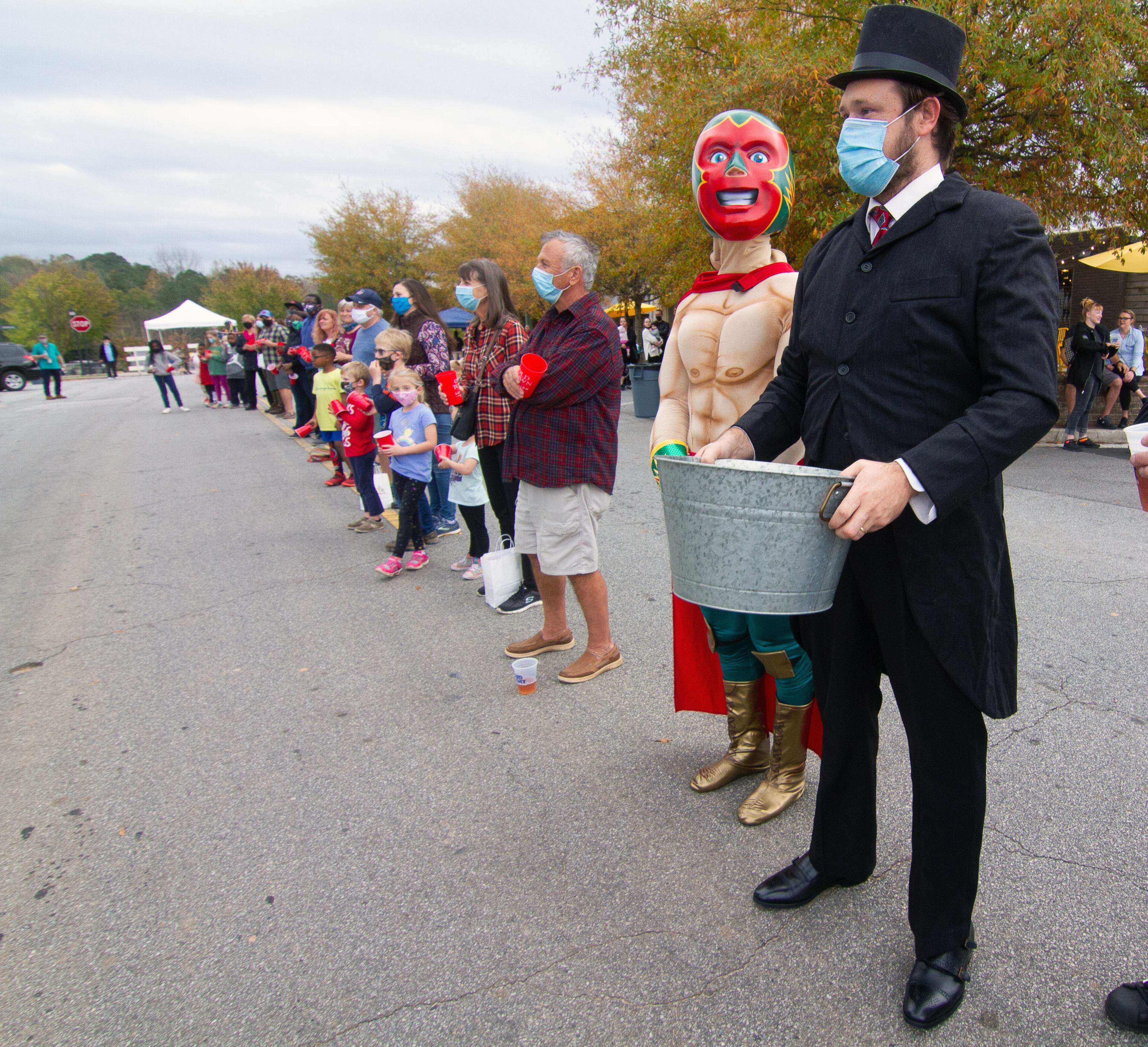 A.J. Passman (right), playing the part of Lilburn Trigg Myers, waits for the start of the bucket brigade reenactment on Sunday, November 15, 2020, to mark the 100th anniversary of when Lilburn was saved from a fire. (Photo: Steve Schaefer for The Atlanta Journal-Constitution)