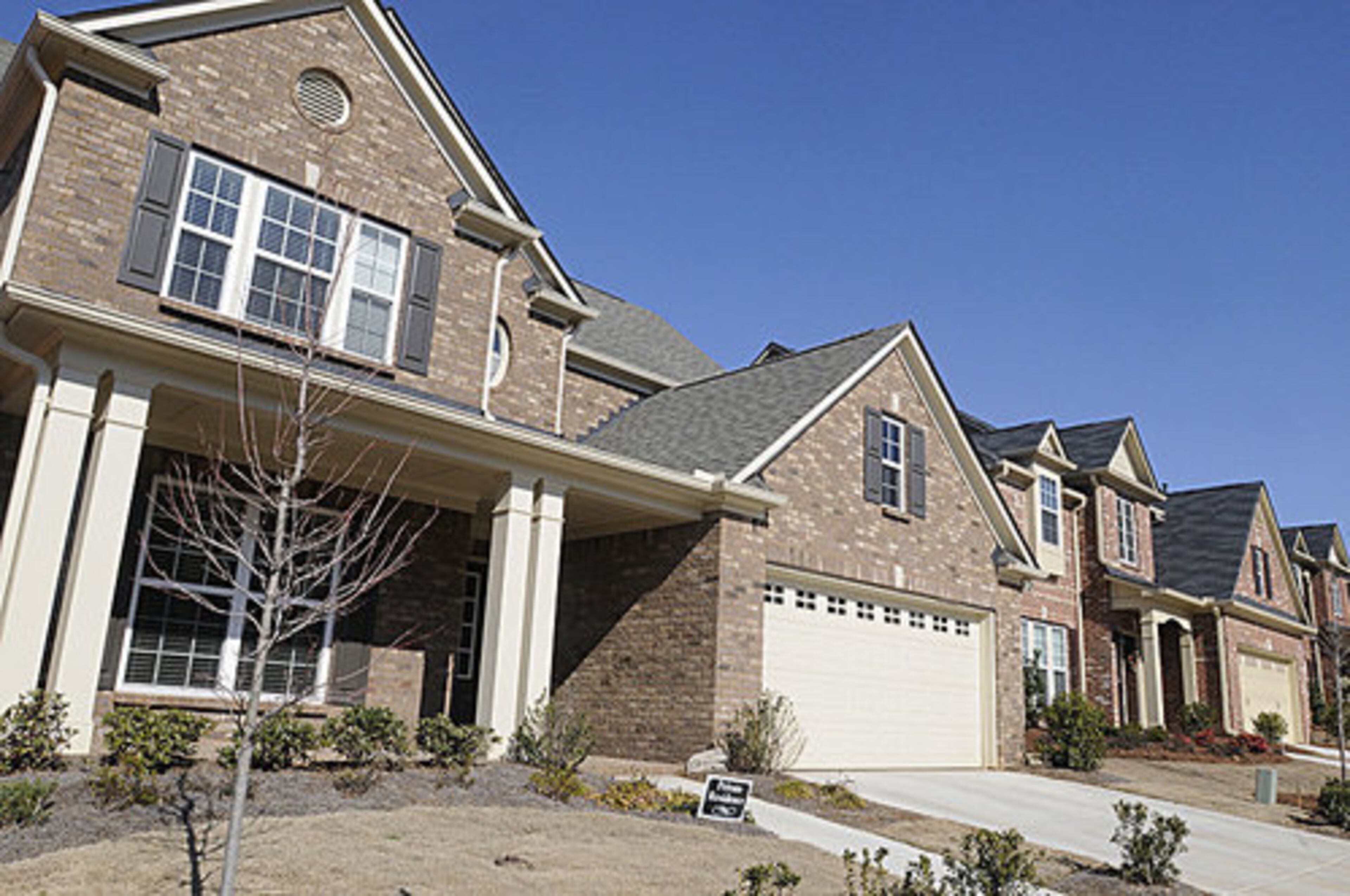 Other standard features at The Gates at Johns Creek include carriage-style garage doors, 9-foot ceilings on first floor, fireplace with slate surround, Whirlpool appliances, garden tub and separate shower in master bath.