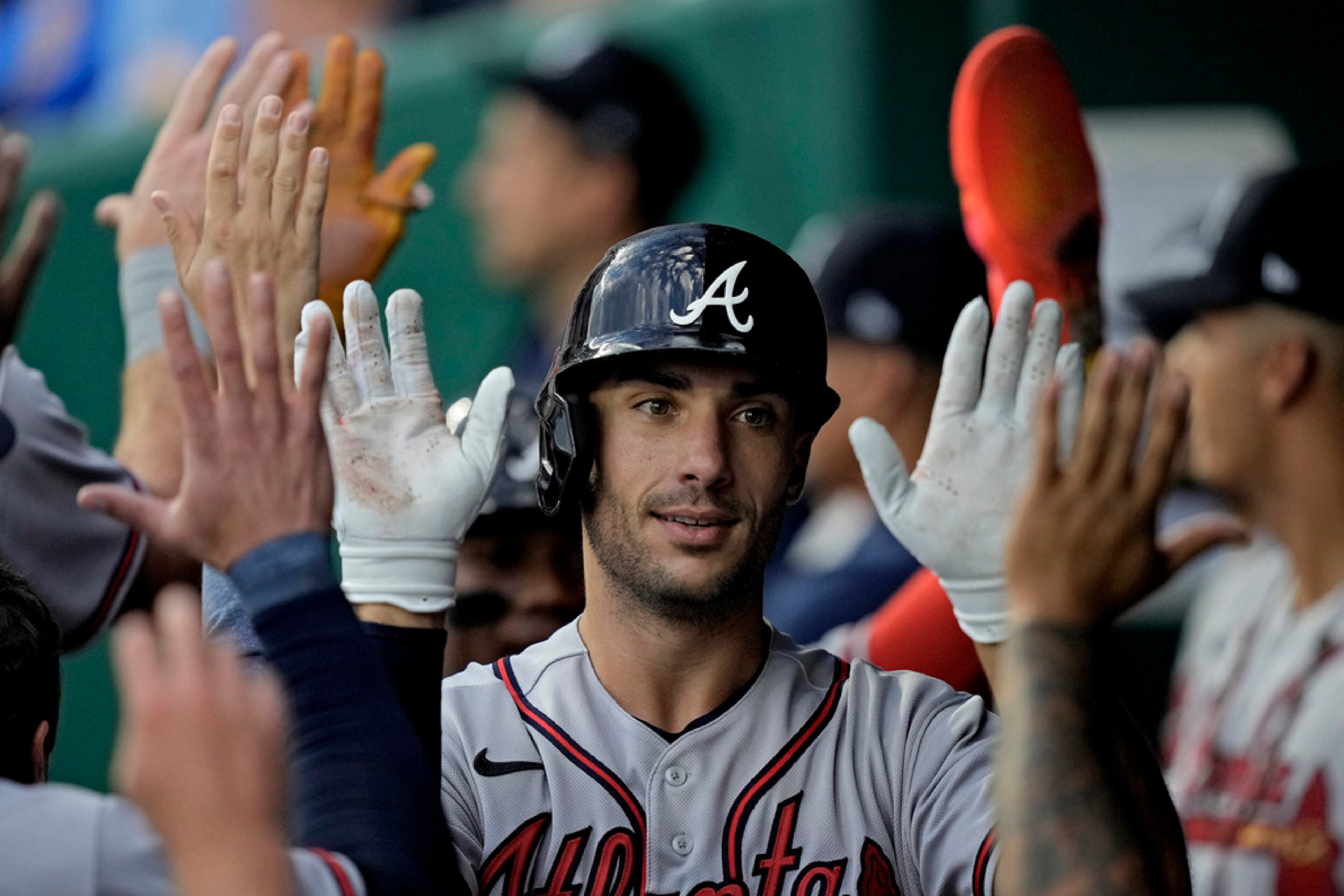 Atlanta Braves' Matt Olson celebrates in the dugout after hitting a solo home run during the first inning of a baseball game against the Kansas City Royals Friday, April 14, 2023, in Kansas City, Mo. (AP Photo/Charlie Riedel)