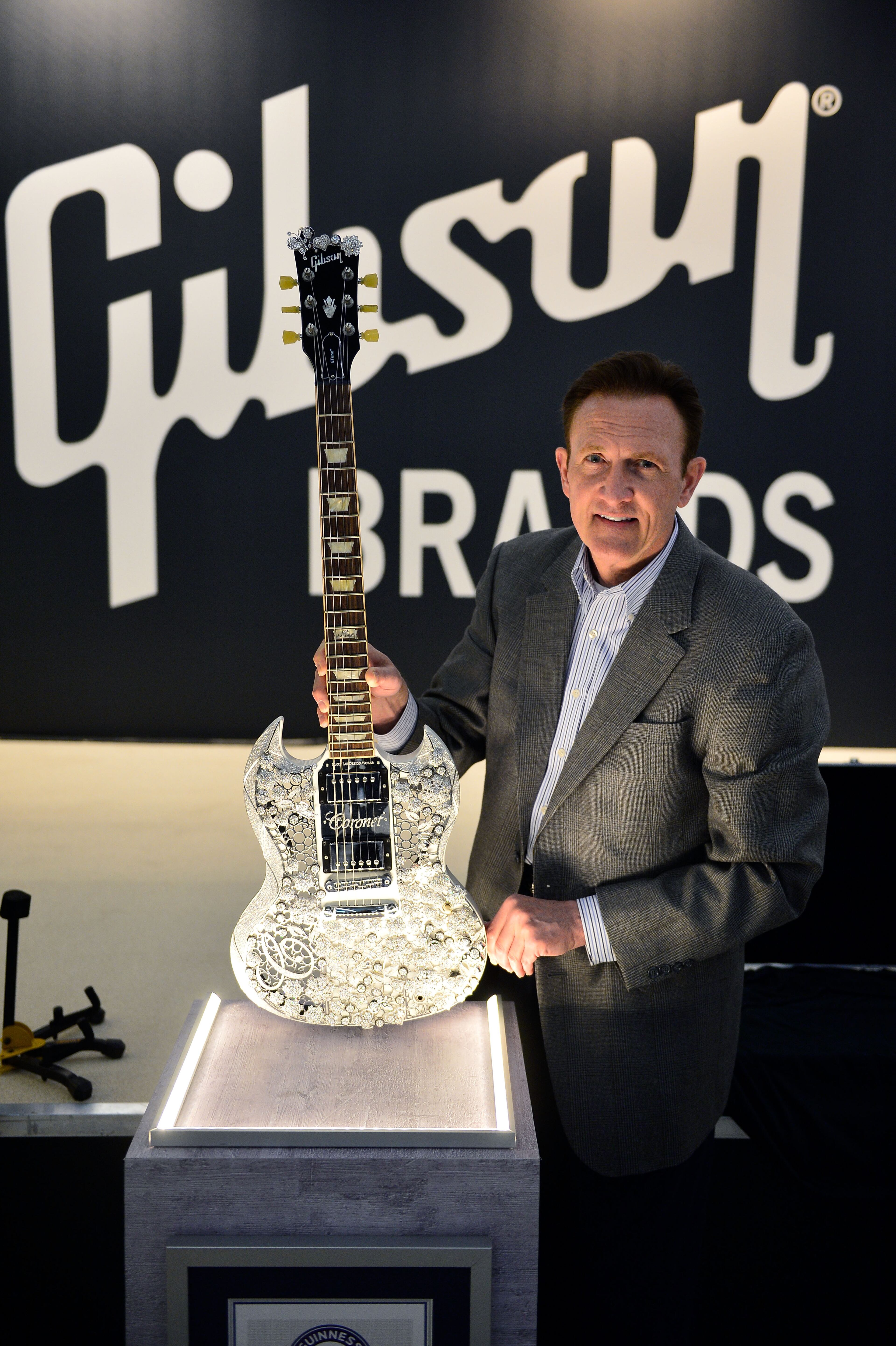 Most valuable guitar in the world FRANKFURT AM MAIN, GERMANY - APRIL 14: Paul Jernigan of Gibson Brands presents the 'Eden of CORONET' guitar, the highlight of this year's Gibson at Musikmesse Frankfurt event on April 14, 2015 in Frankfurt am Main, Germany. The guitar is a collaboration between the Chinese jewelry manufacturer Aaron Shum Jewelry and musician and designer Mark Lui. The guitar consists of 400 carats of diamonds and 1.6 kg of18-carat gold. Worth 2 million US-Dollars, the SG-model of Gibson is the most valuable guitar in the world and is documented in the Guinness Book of Records. (Photo By Thomas Lohnes/Getty Images for Gibson)