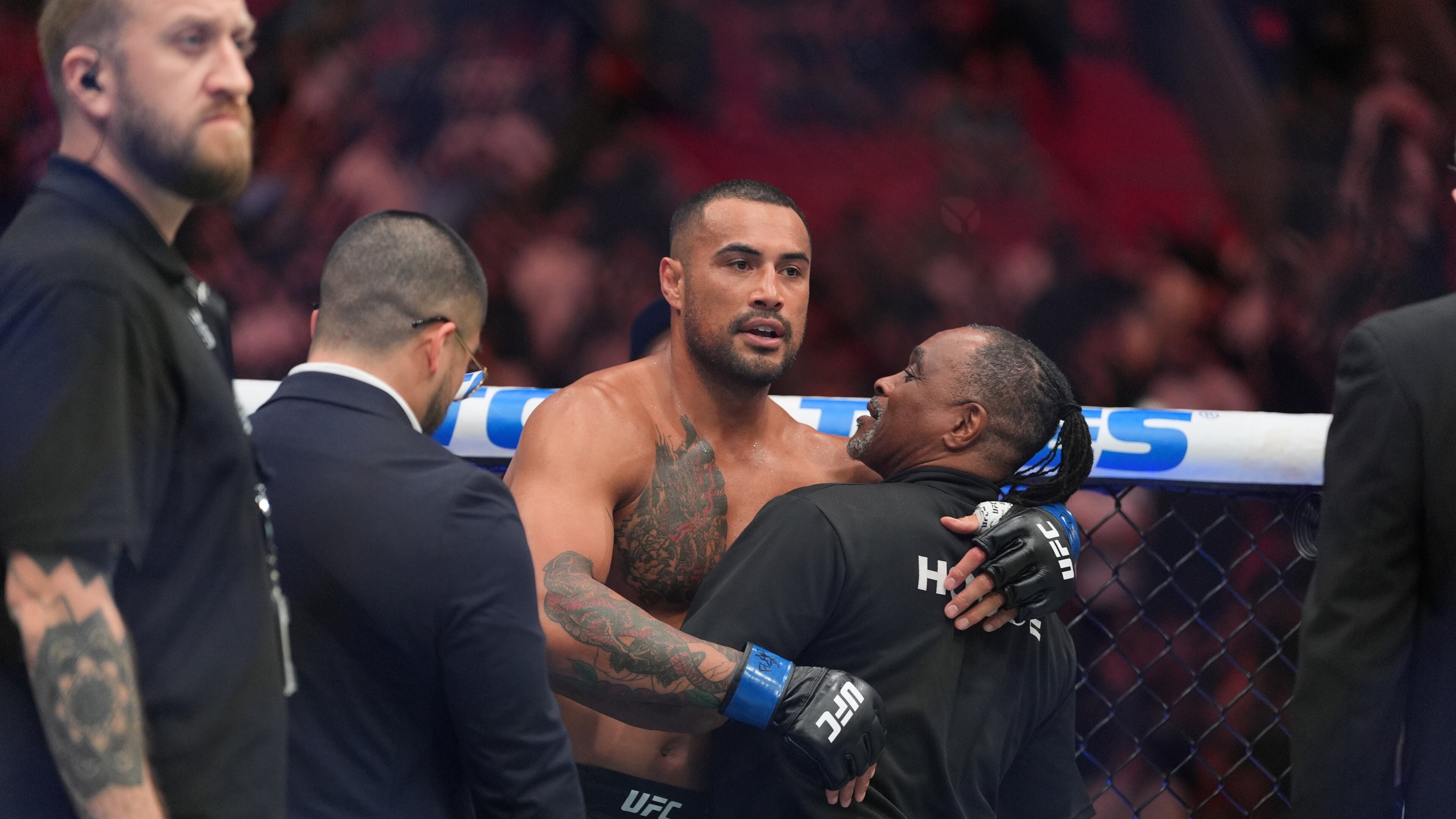 Carlos Ulberg, center, of New Zealand, reacts after defeating Jiri Prochazka, of Czechia, by TKO to win their light heavyweight title bout at a UFC 327 mixed martial arts event, Saturday, April 11, 2026, in Miami. (AP Photo/Rebecca Blackwell)