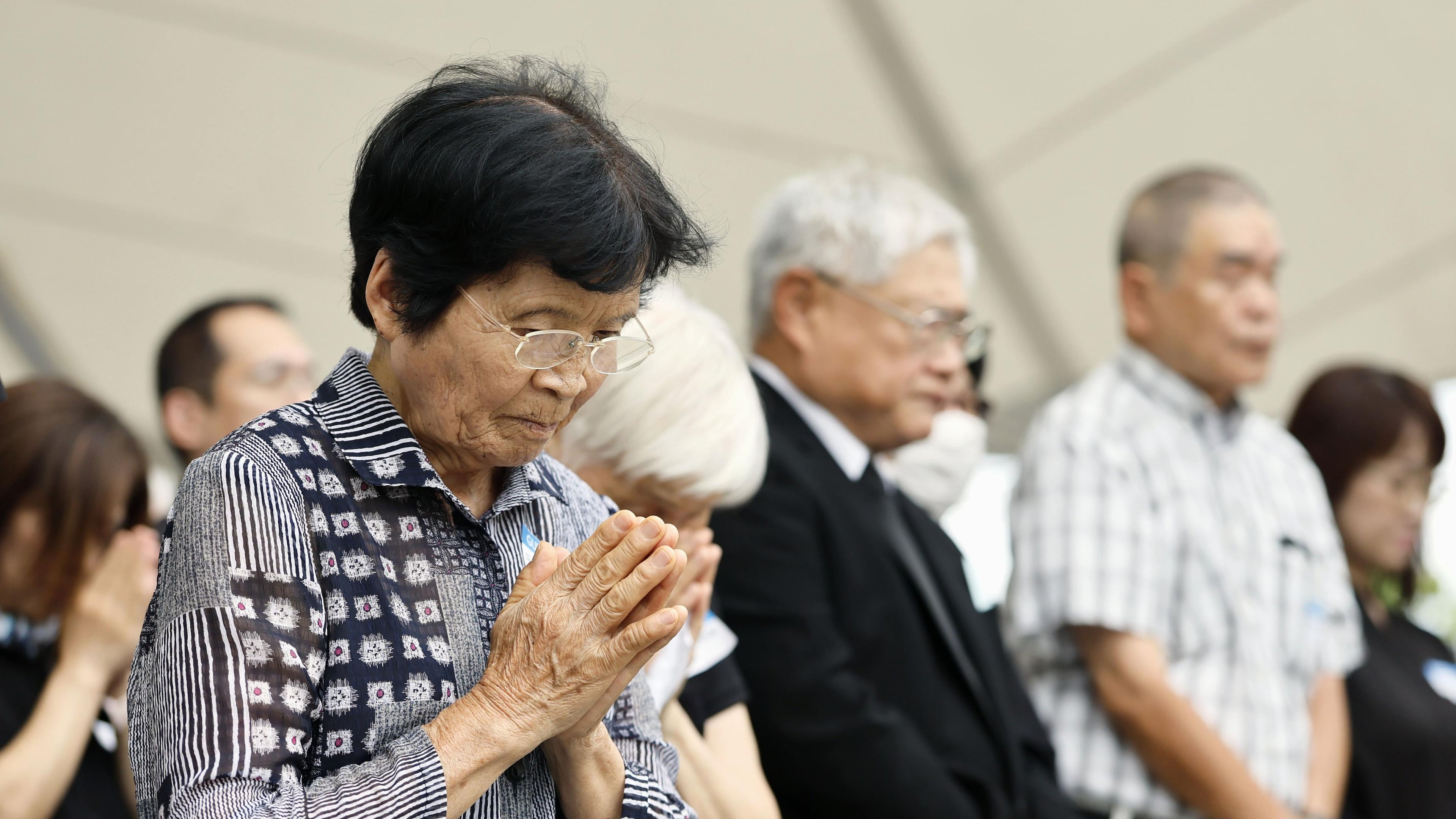 People observe a minute of silence during a ceremony to mark the 81st anniversary of the U.S. atomic bombing at the Peace Park in Nagasaki, southern Japan Sunday, Aug. 9, 2026. (Taichi Nagahisa/Kyodo News via AP)
