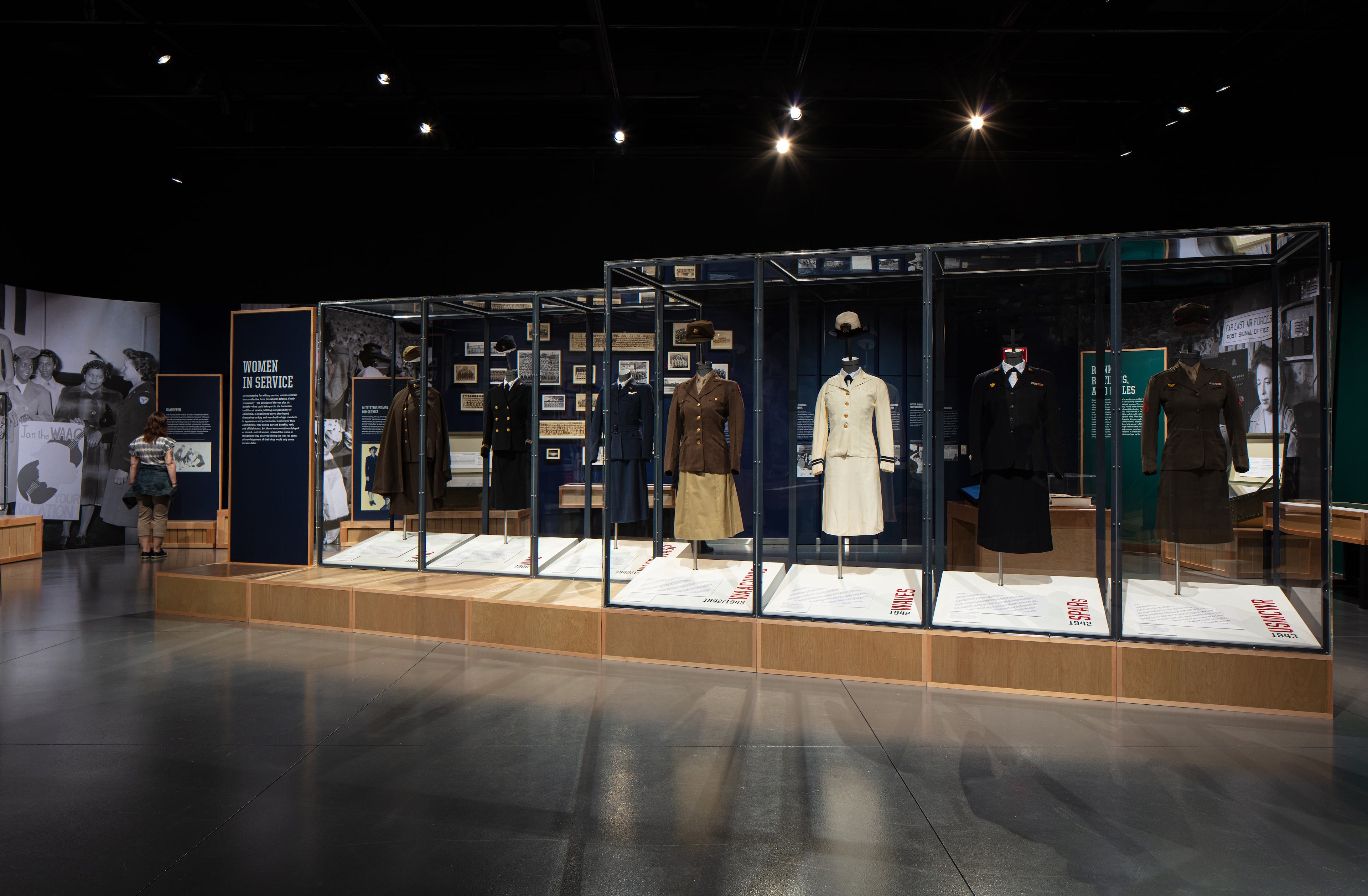 A long display of military uniforms worn by women in WWII is a cornerstone of the exhibition. Each uniform represented a different branch of service women volunteered for. (Courtesy of National WWII Museum)