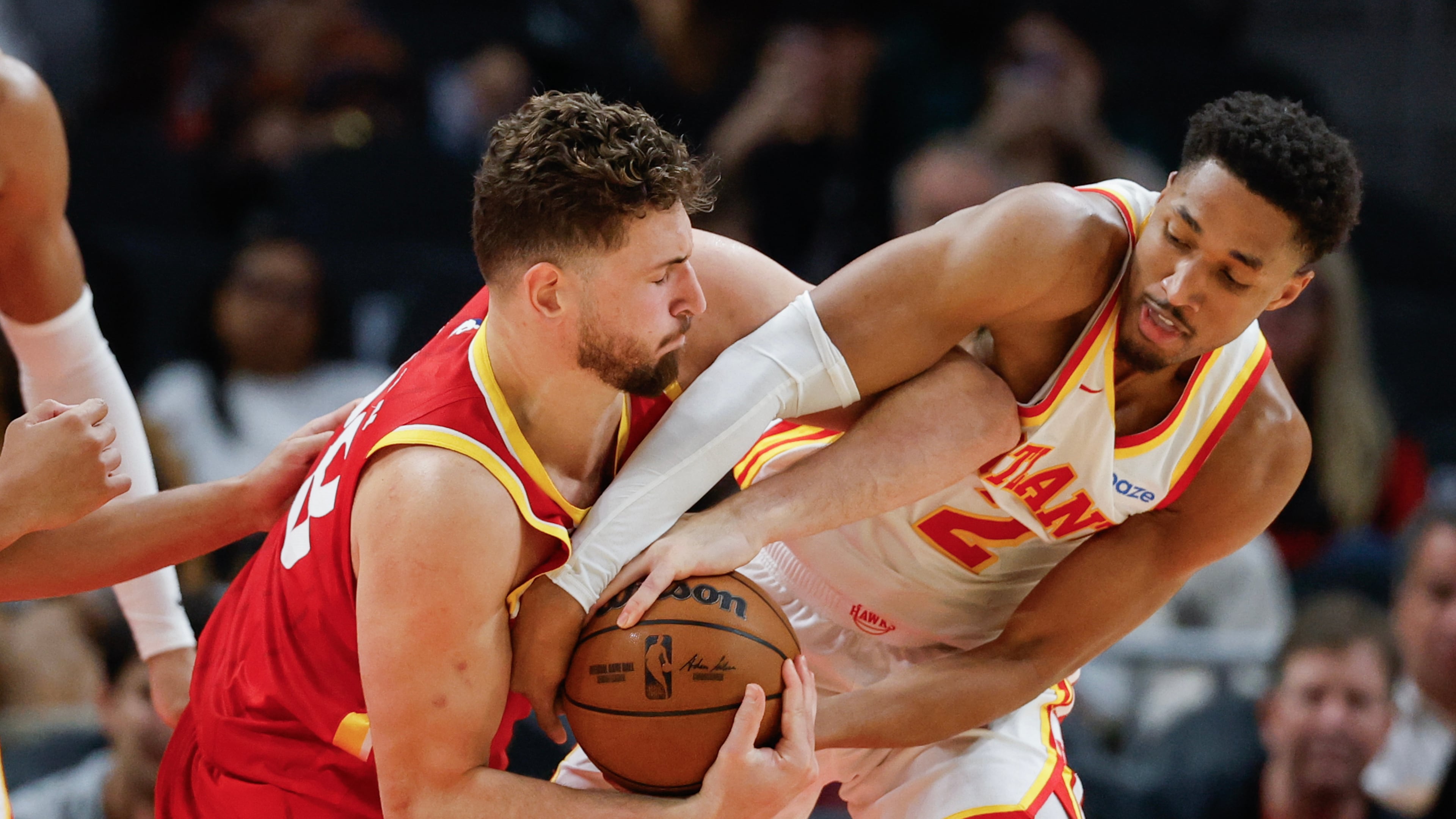 Rockets center Alperen Sengun (left) tries to keep the ball away from Hawks guard Aaron Wiggins during the second half Saturday, Oct. 24, 2026, in Atlanta. Sengun scored 17 points and had 10 rebounds and seven assists. (Erik S. Lesser/AP)