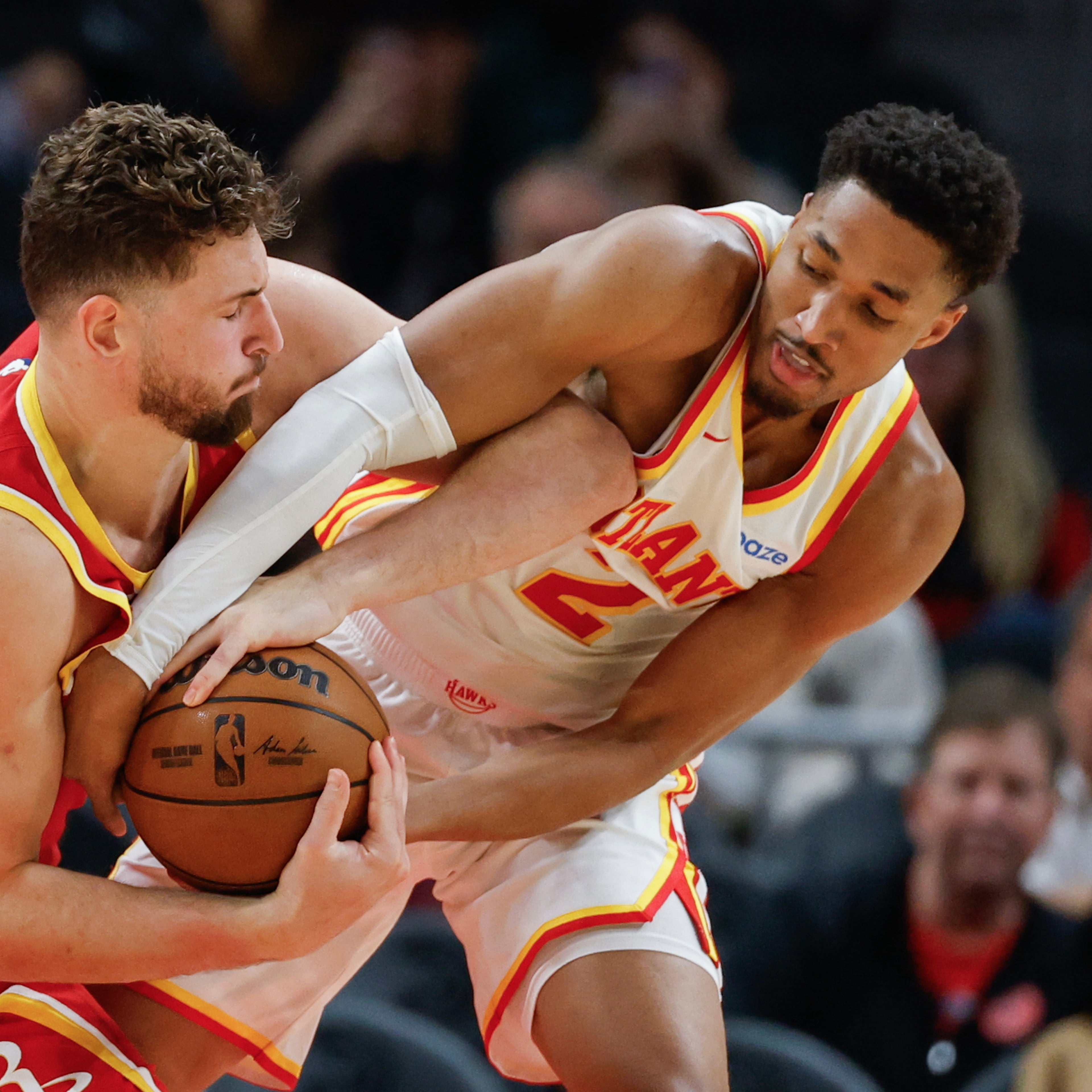 Rockets center Alperen Sengun (left) tries to keep the ball away from Hawks guard Aaron Wiggins during the second half Saturday, Oct. 24, 2026, in Atlanta. Sengun scored 17 points and had 10 rebounds and seven assists. (Erik S. Lesser/AP)