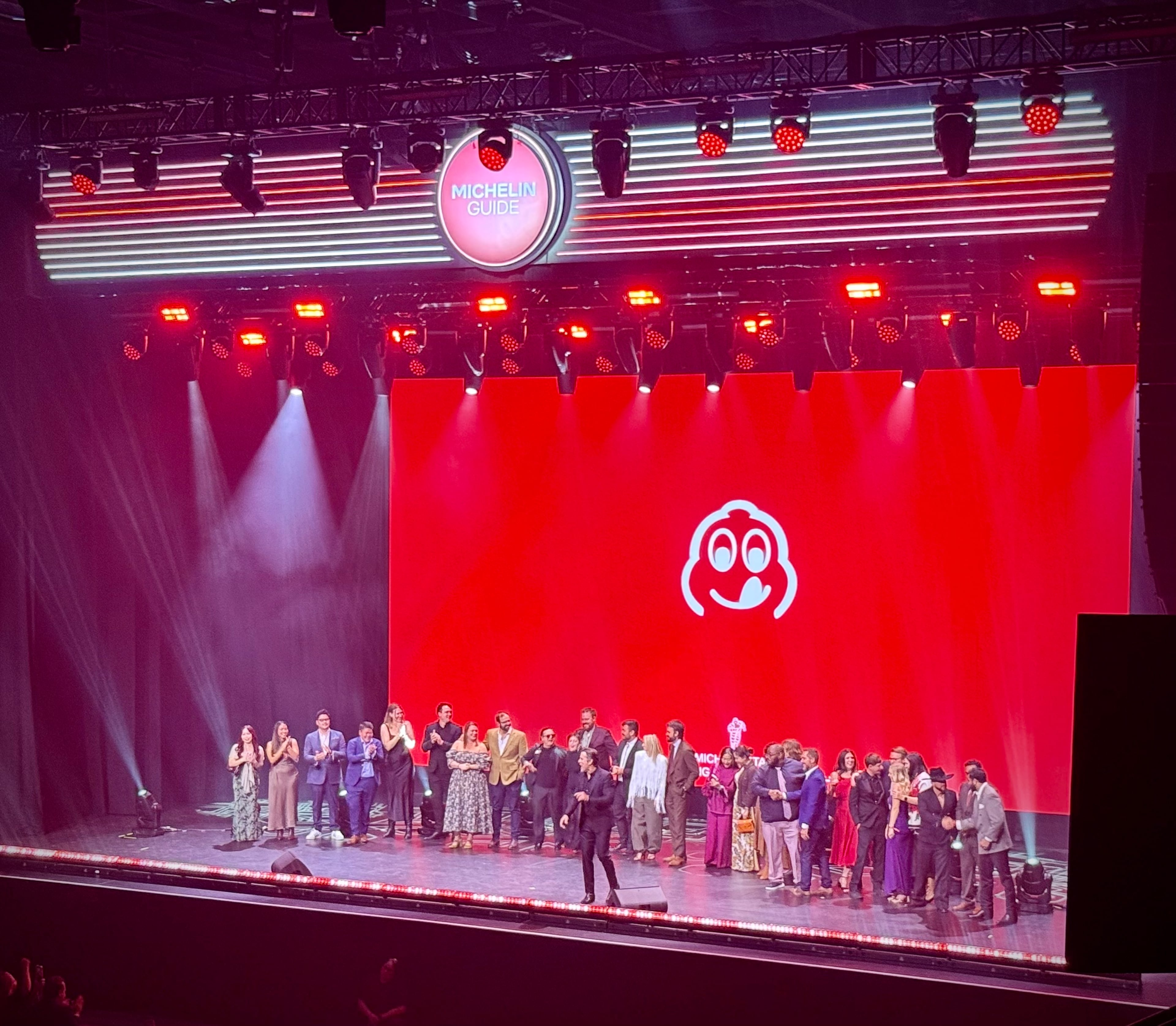 The new Bib Gourmand honorees gather on stage at the 2026 Michelin Guide American South ceremony in Nashville. (Henri Hollis/AJC)