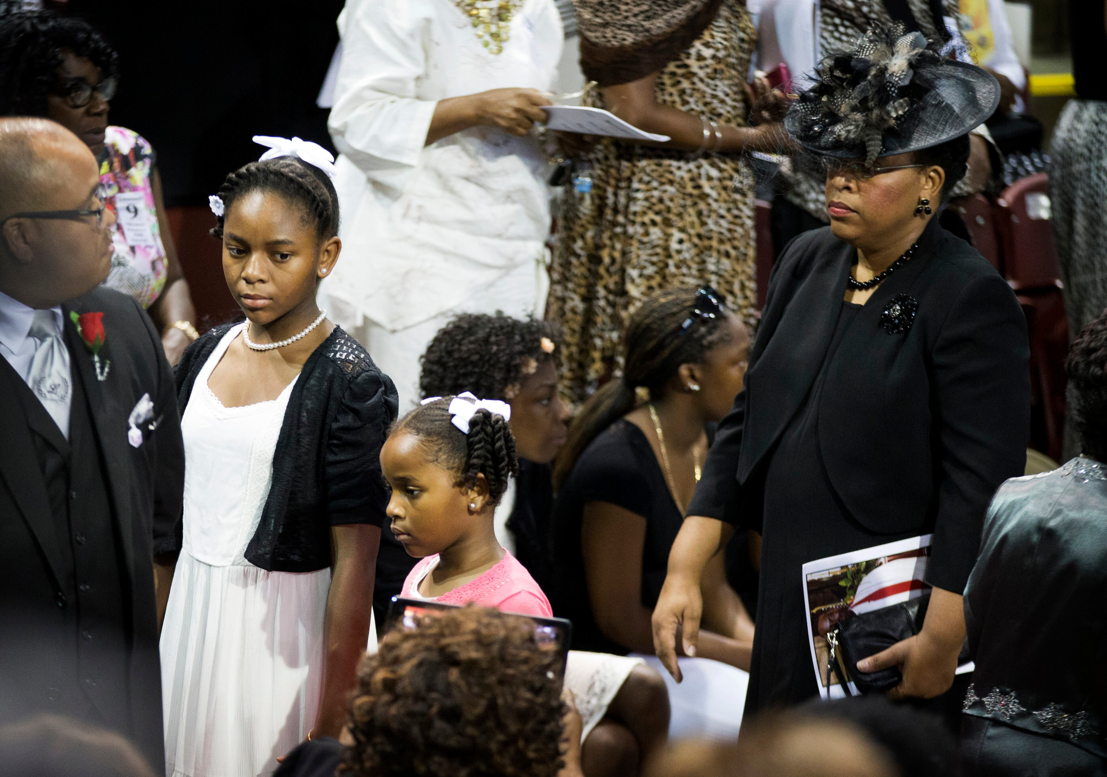 Sen. Clementa Pinckney's wife Jennifer Pinckney, right, and daughters Eliana, left, and Malana walk in for his funeral service, Friday, June 26, 2015, in Charleston, S.C. President Barack Obama will deliver the eulogy at Pinckney's funeral at College of Charleston's TD Arena near the Emanuel AME Church, the scene of last week's shooting. (AP Photo/David Goldman)