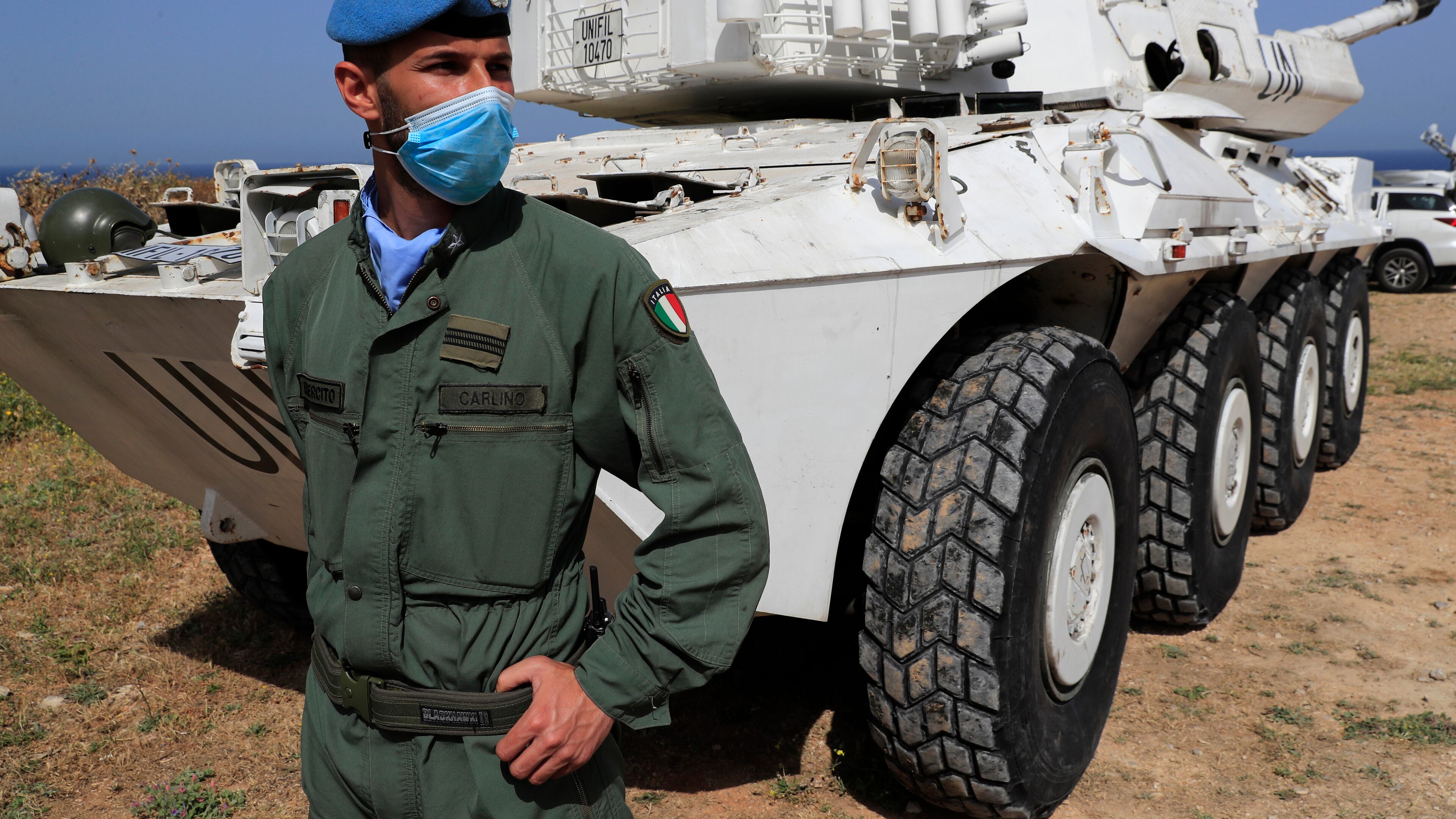 FILE - An Italian U.N. peacekeeper soldier stands guard at a road that links to a United Nations Interim Force In Lebanon, or UNIFIL base, in Naqoura town, Lebanon, on May 4, 2021. (AP Photo/Hussein Malla, File)