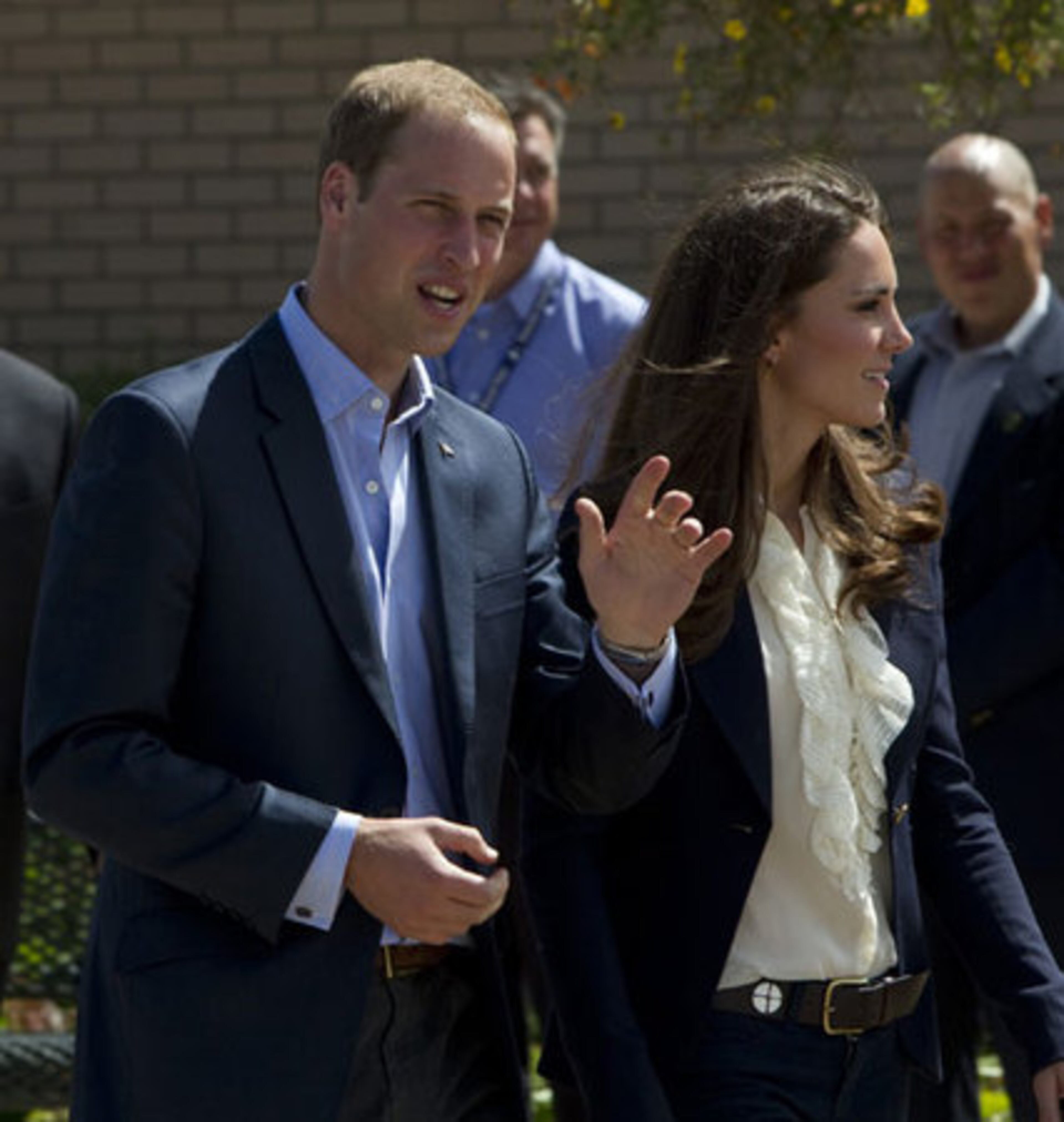 Prince William gestures as he walks with wife Kate, the Duke and Duchess of Cambridge, through Slave Lake.