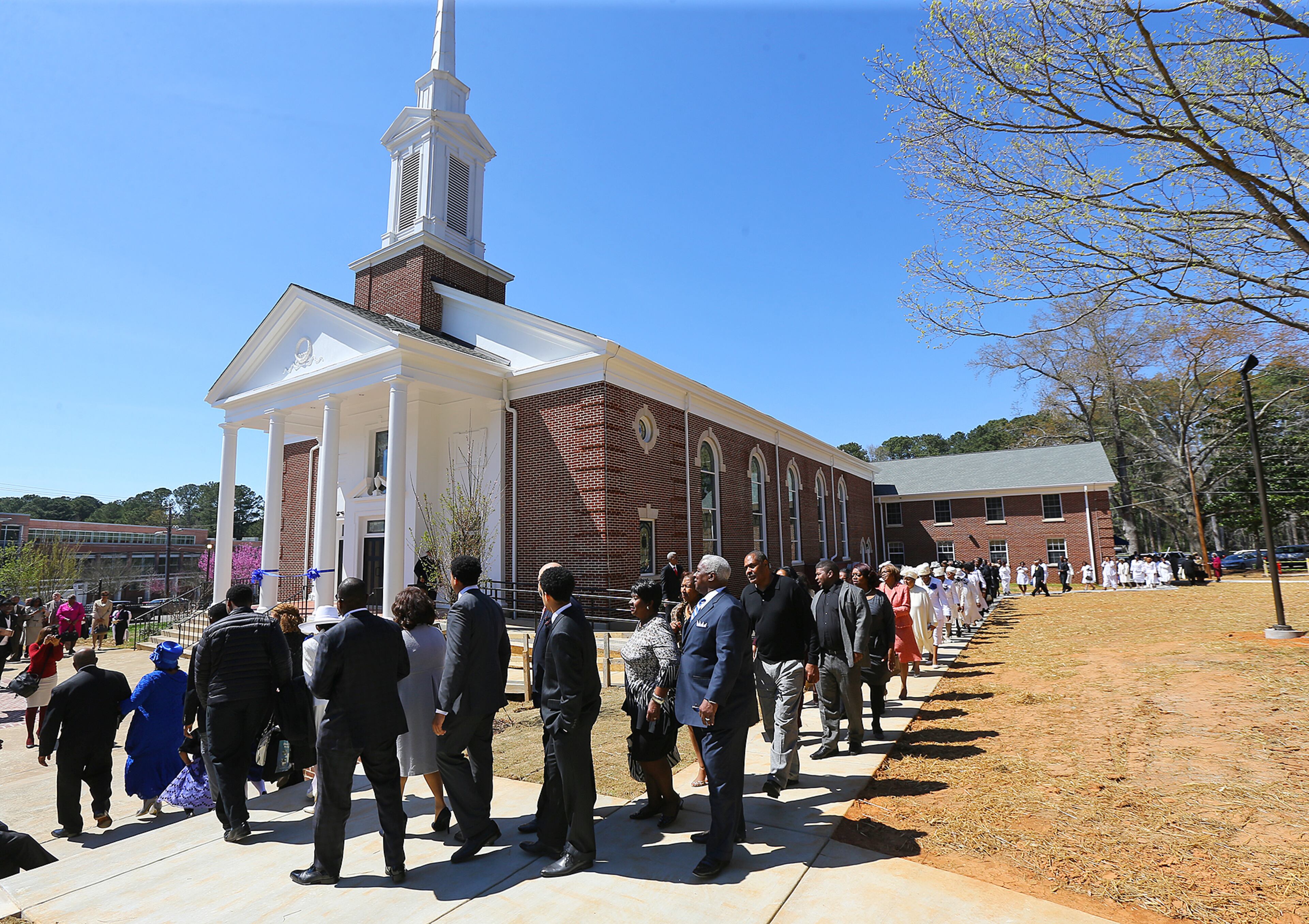 Pastor R.K. Turner and First Lady LaNett Turner (far left) lead the Entrance Processional to the ribbon cutting to begin the Entrance Service at Mount Vernon Baptist Church on Palm Sunday, March 29, 2015, in Atlanta. The church moved locations to make way for the Falcons new stadium. Curtis Compton / ccompton@ajc.com