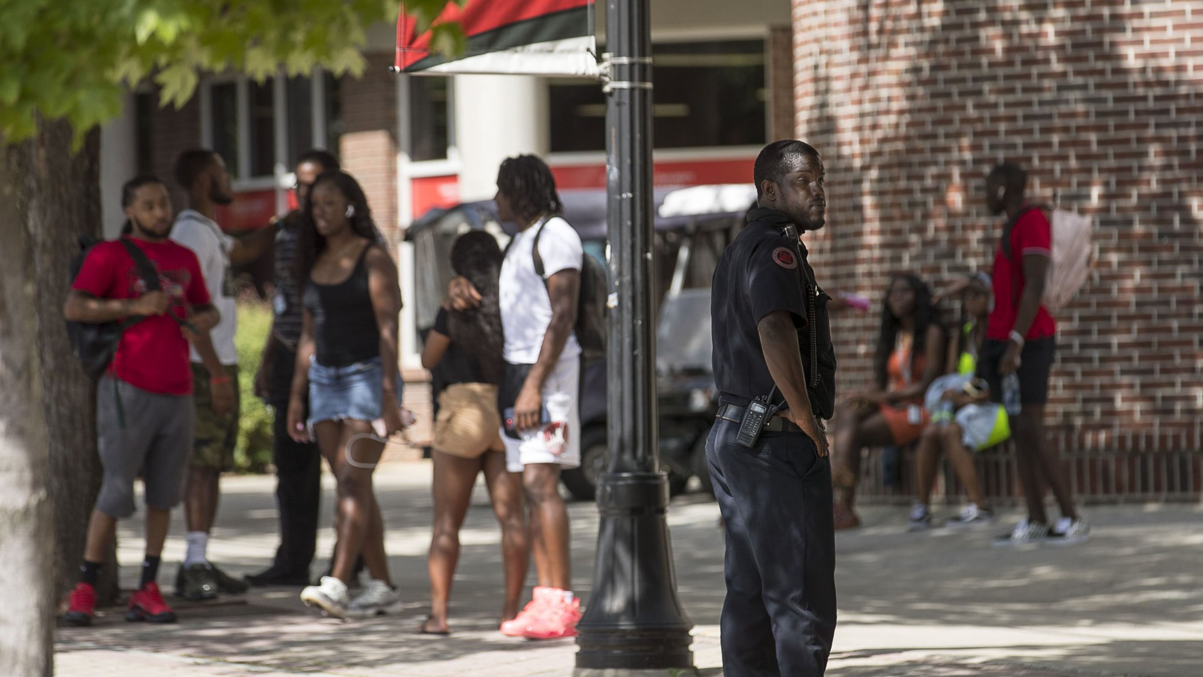 A Clark Atlanta University Police officer keeps an eye out as students socialize near the Clark Atlanta University student center on the main campus in Atlanta, Wednesday, August 21, 2019. The night before, a shooting took place on the promenade, an area near the library, injuring 2 Clark Atlanta University students and 2 Spelman College students. (Photo: Alyssa Pointer/alyssa.pointer@ajc.com)