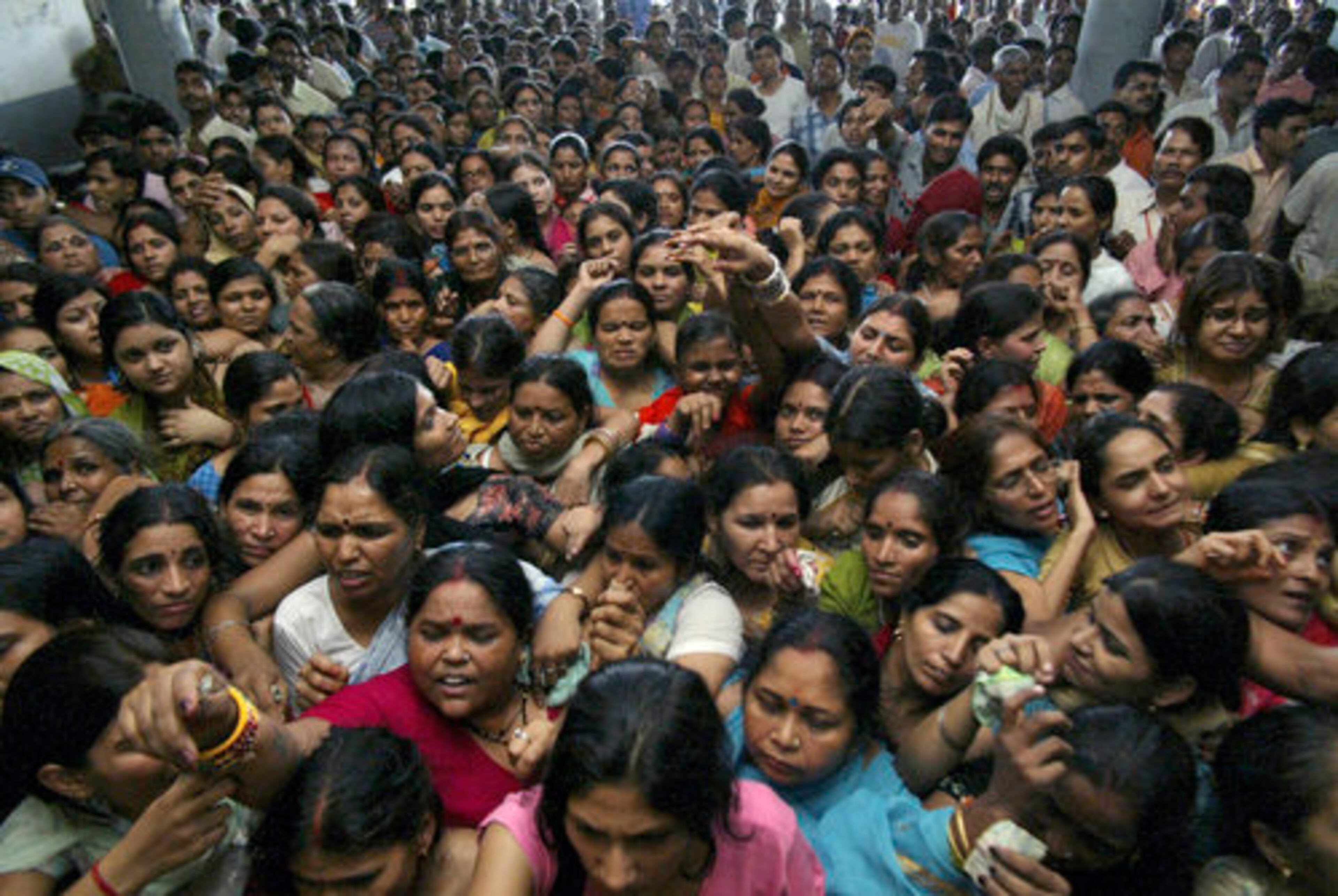 Passengers line up at a railway station to get tickets during a transportation strike in Jammu, India, on Monday.