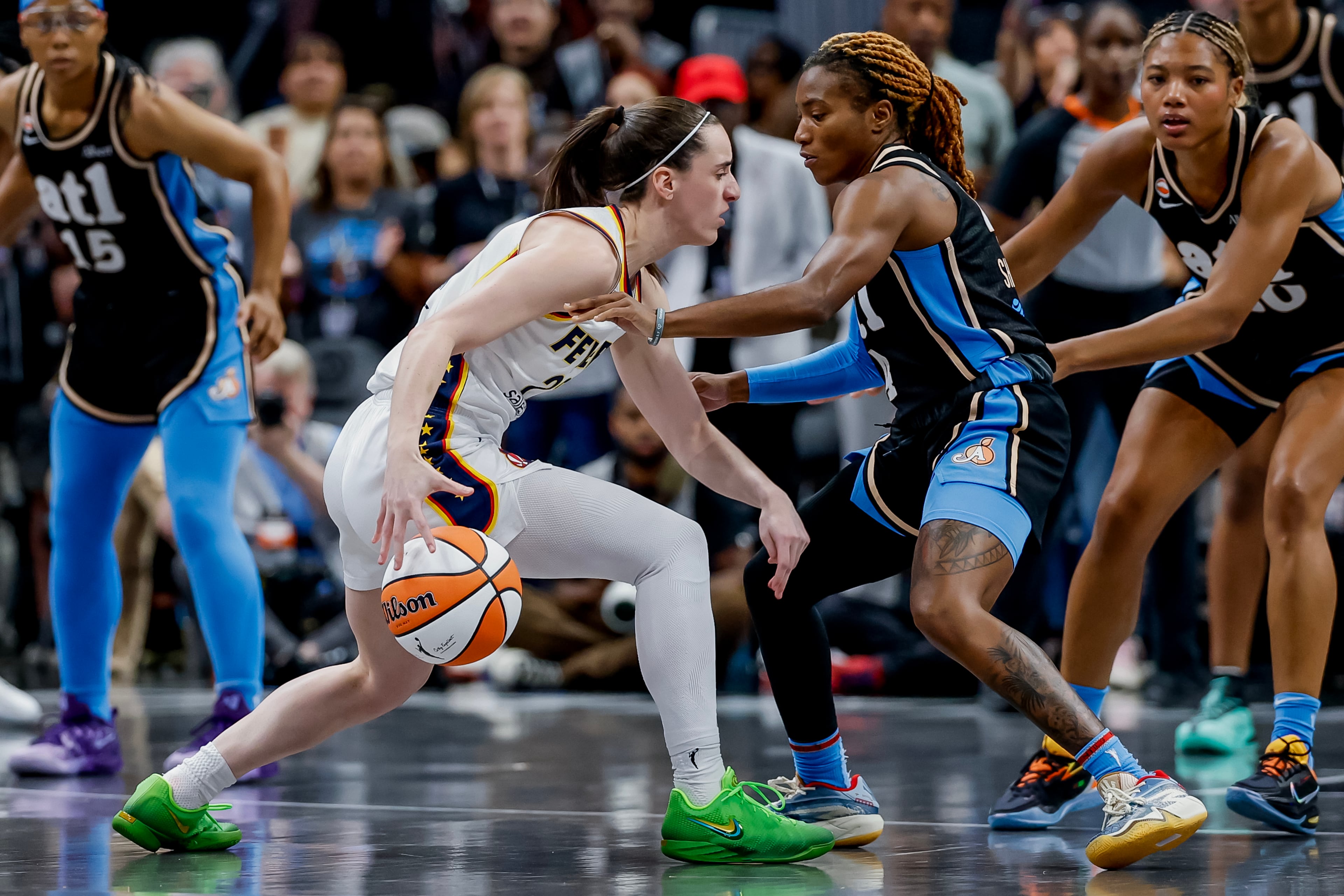 Clark (left) drives against Dream guard Jaylyn Sherrod. (Erik S. Lesser for the AJC)