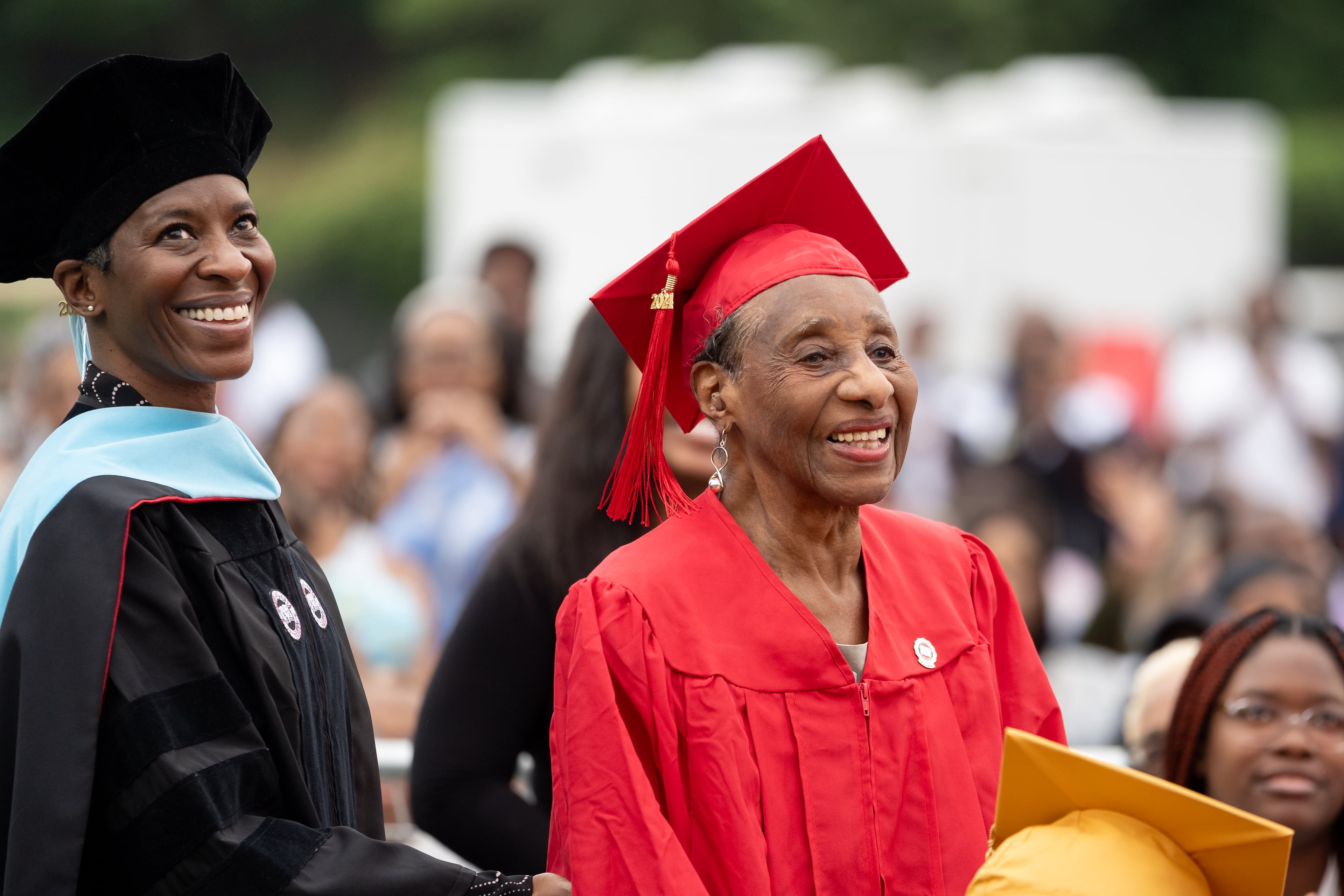 A 102-year-old legacy alumna stands as the crowd cheers. Graduates, faculty and family gather for the Clark Atlanta University 35th annual commencement convocation. Saturday, May 18, 2024 (Ben Hendren for The Atlanta Journal-Constitution)
