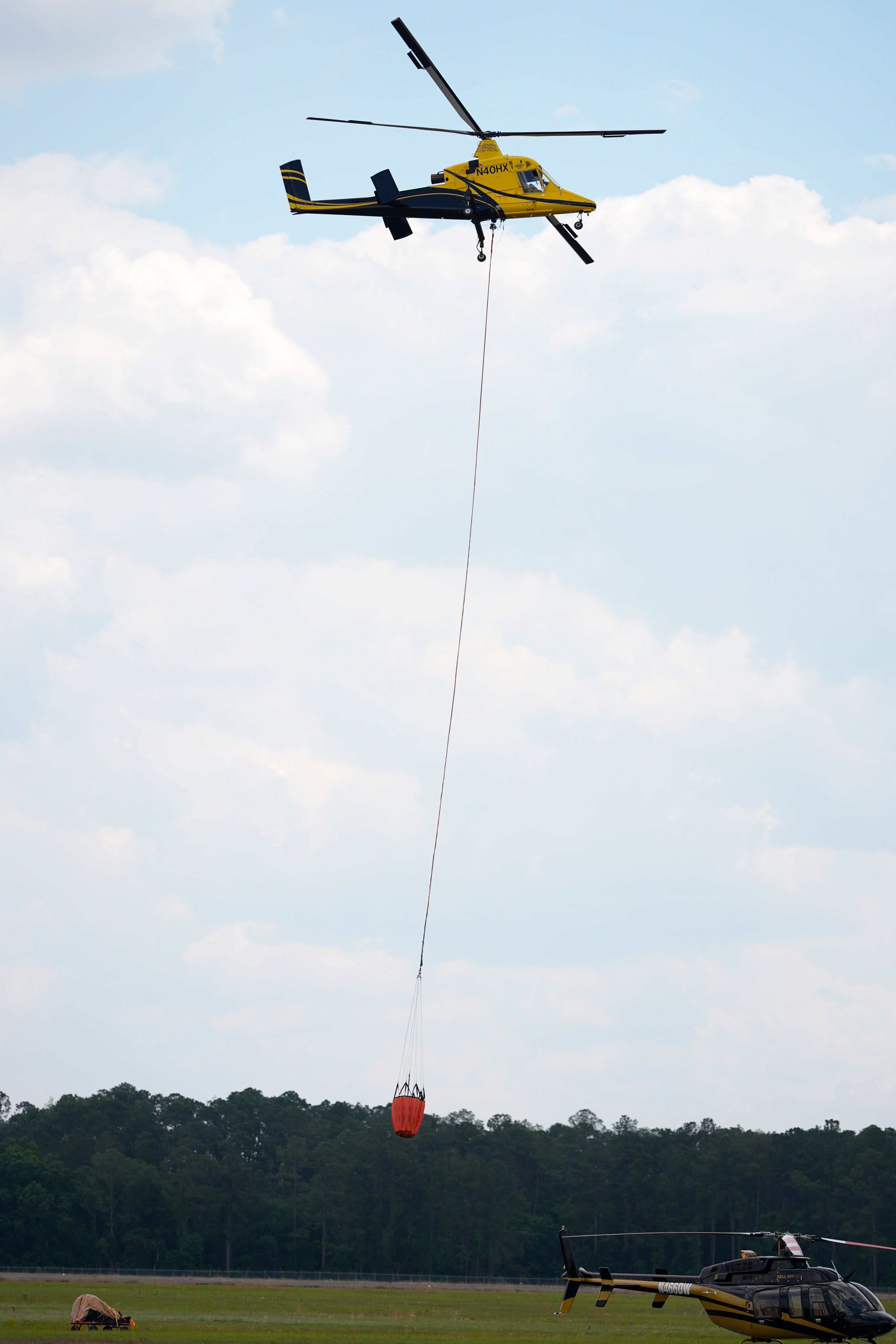 A firefighting helicopter takes off from the airport as it heads toward fires in southeast Georgia, Friday, April 24, 2026, in Waycross, Ga. (Mike Stewart/AP)