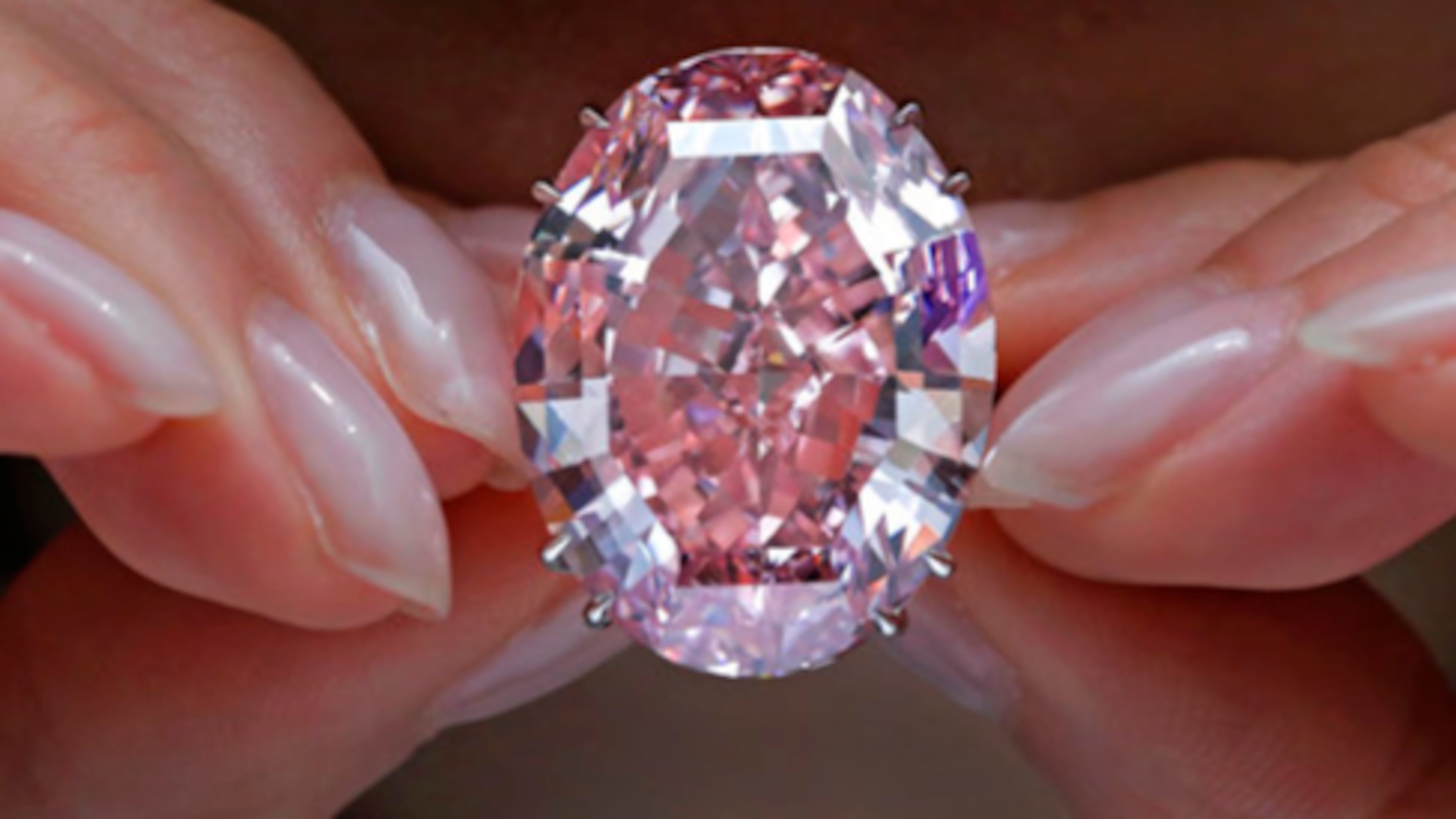 The Pink Star diamond, the most valuable cut diamond ever offered at auction, is displayed by a model at a Sotheby's auction room in Hong Kong. It is the largest internally flawless fancy vivid pink diamond ever graded by the Gemological Institute of America.